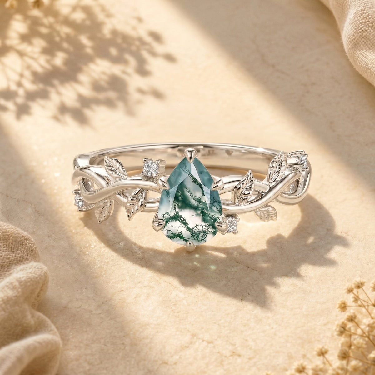 The Nimue pear-cut moss agate solitaire: an Awareness Avenue design, not a men's band.