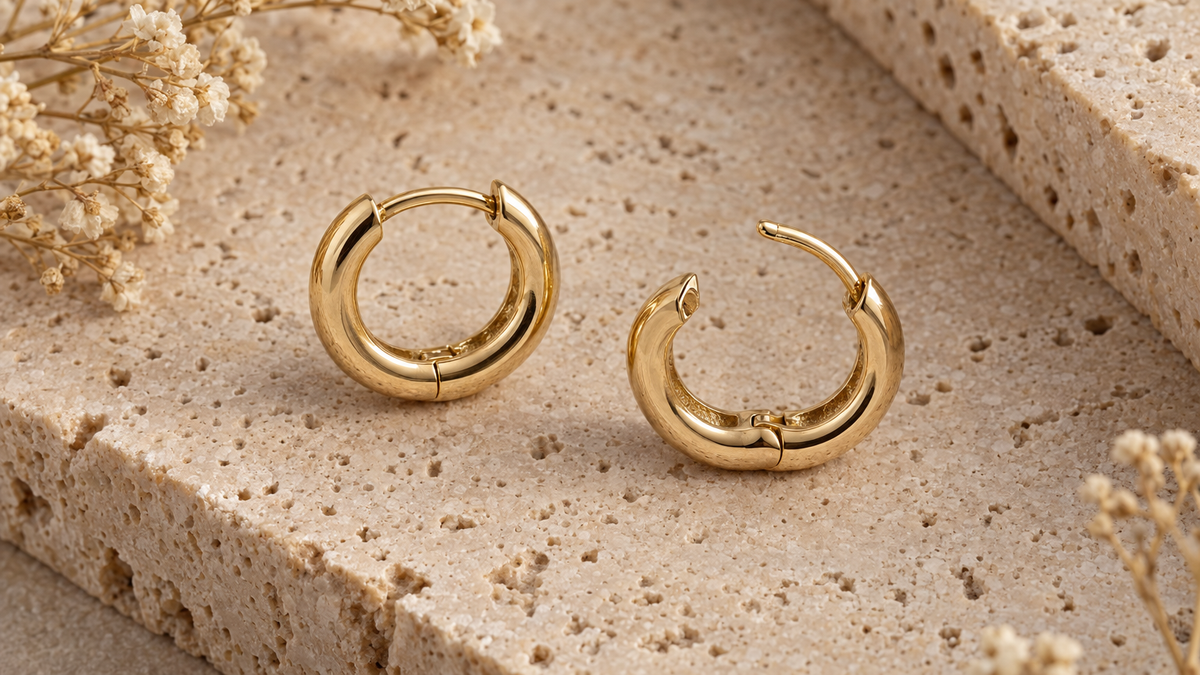 Illustrative gold-tone hinged hoop earrings on stone; not verified depictions of listed products, materials or dimensions.