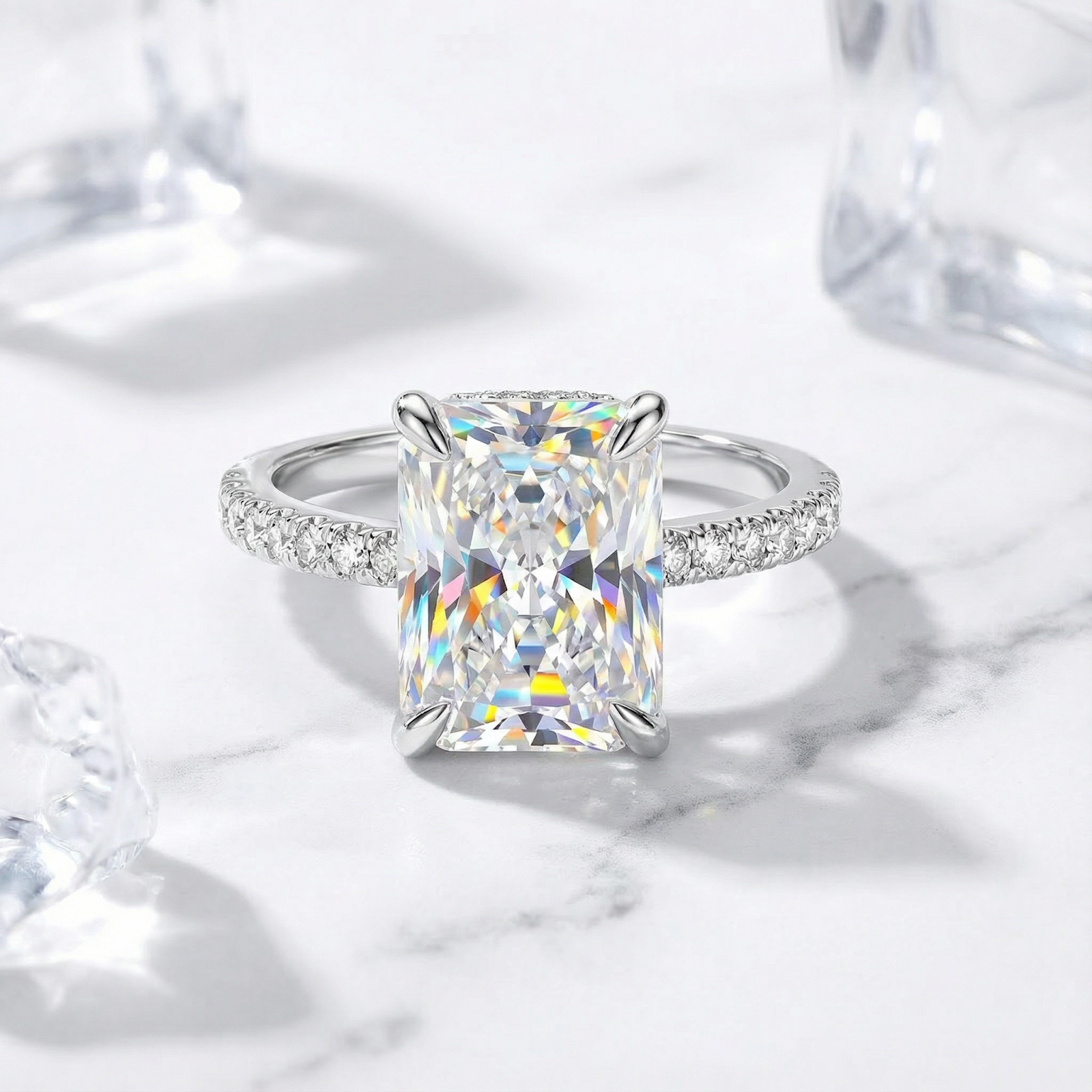 Close-up of a silver-toned ring with a large rectangular clear stone and pavé accent stones along the band.