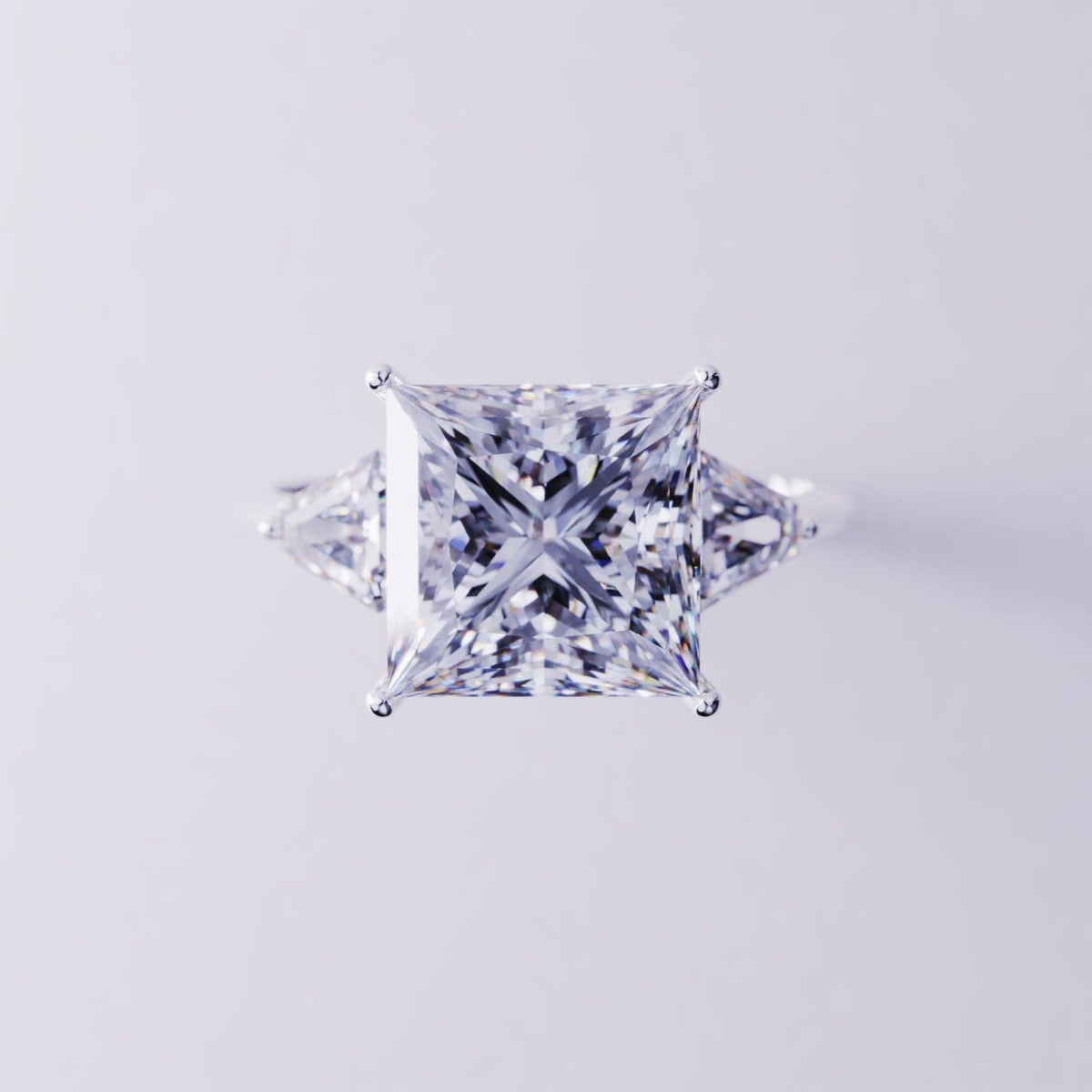 Silver-toned ring with a large square-cut center stone and two triangular side stones.