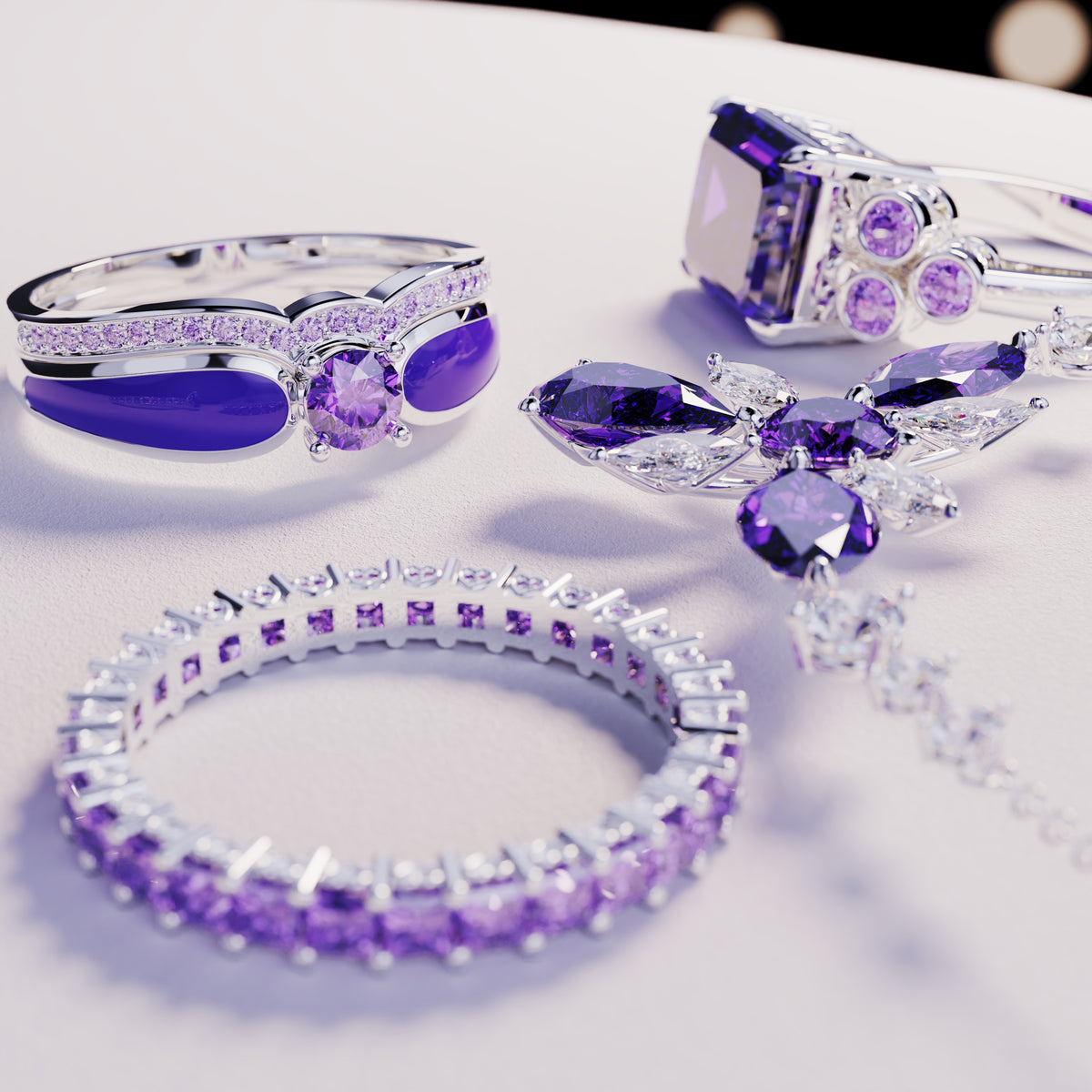 Several silver-toned jewelry pieces with purple and clear gemstones on a white surface.