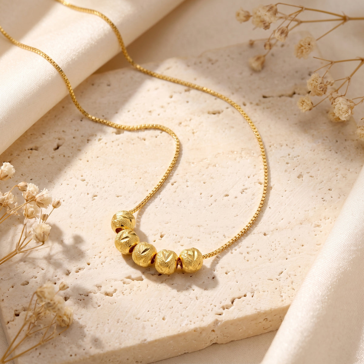 The Carved Bead Station Necklace