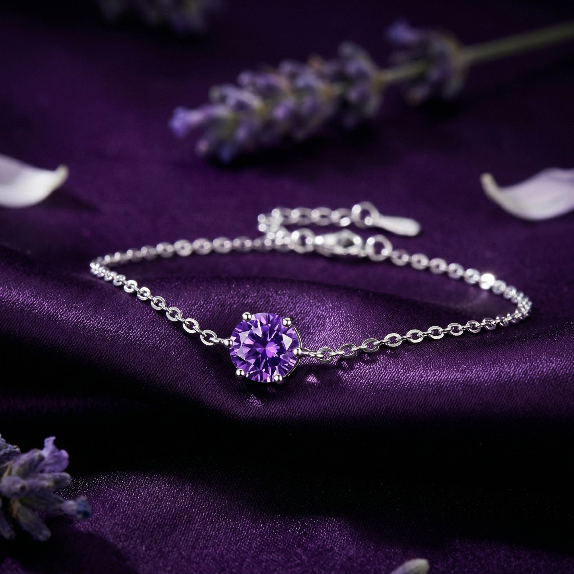 Sterling silver bracelet with a round amethyst solitaire on purple silk fabric with lavender sprigs.