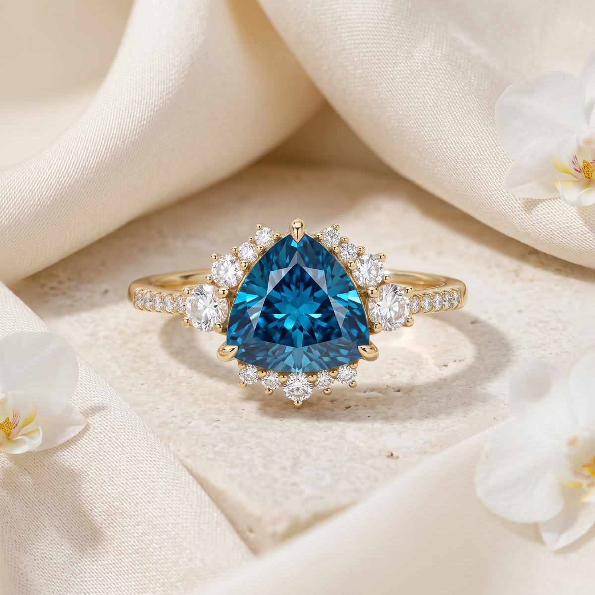 Front view of a trillion-cut blue moissanite halo ring in yellow gold.