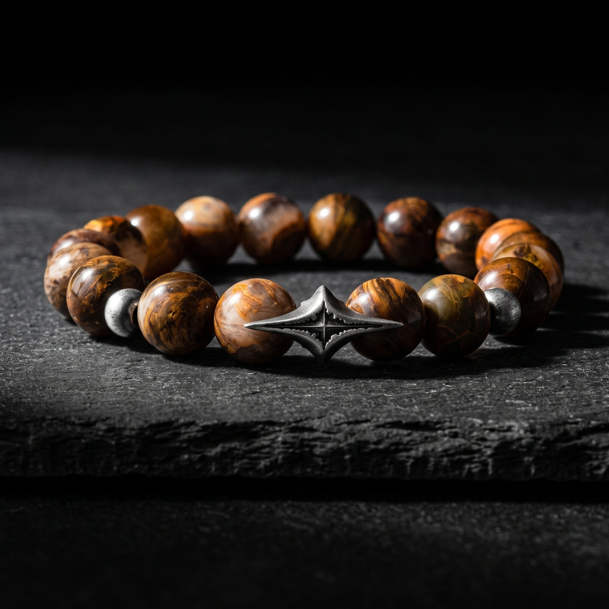 North Star beaded bracelet with brown gemstone beads and a silver four-pointed star station on dark slate