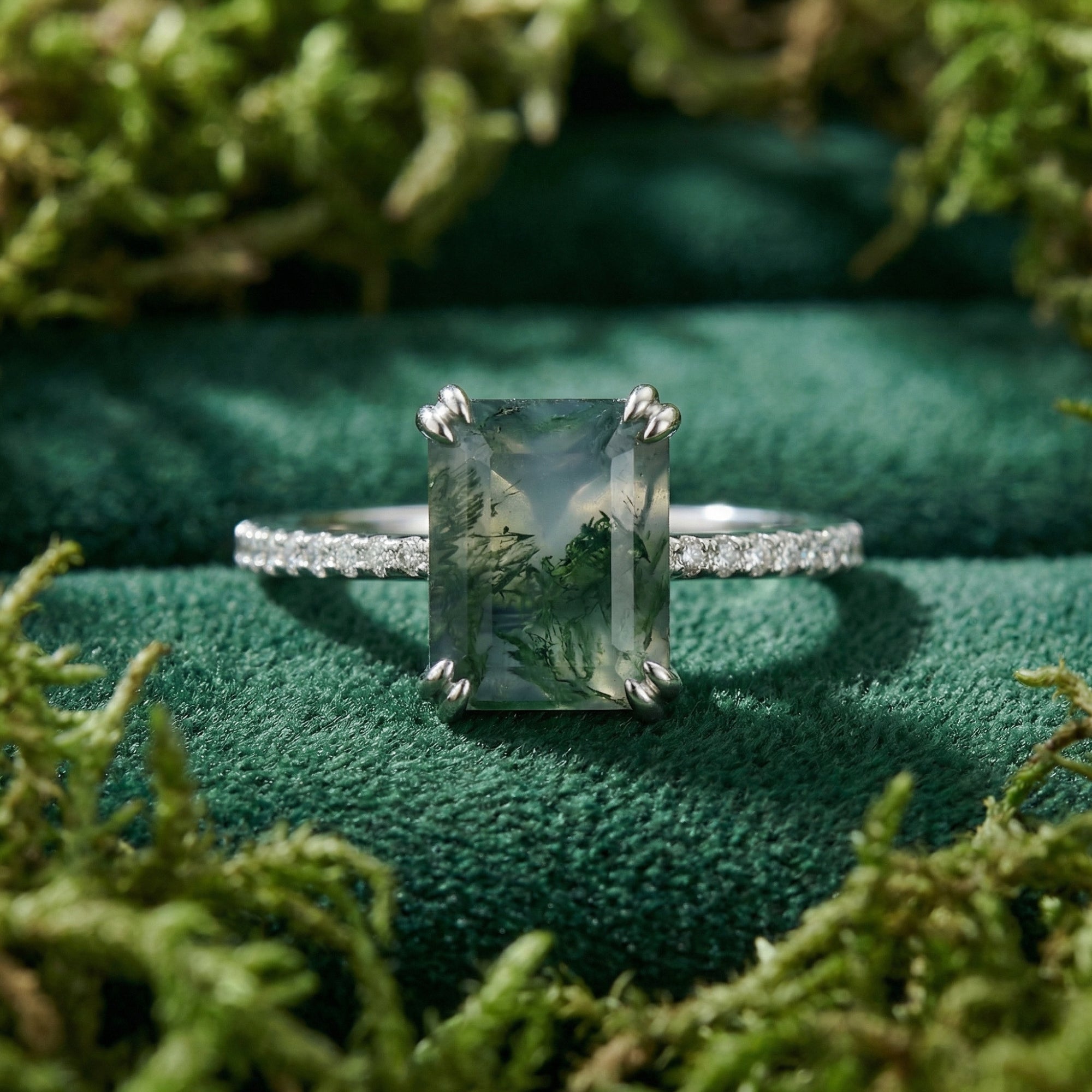 Rectangular moss agate ring in S925 sterling silver with pavé diamonds on a green velvet and moss background.