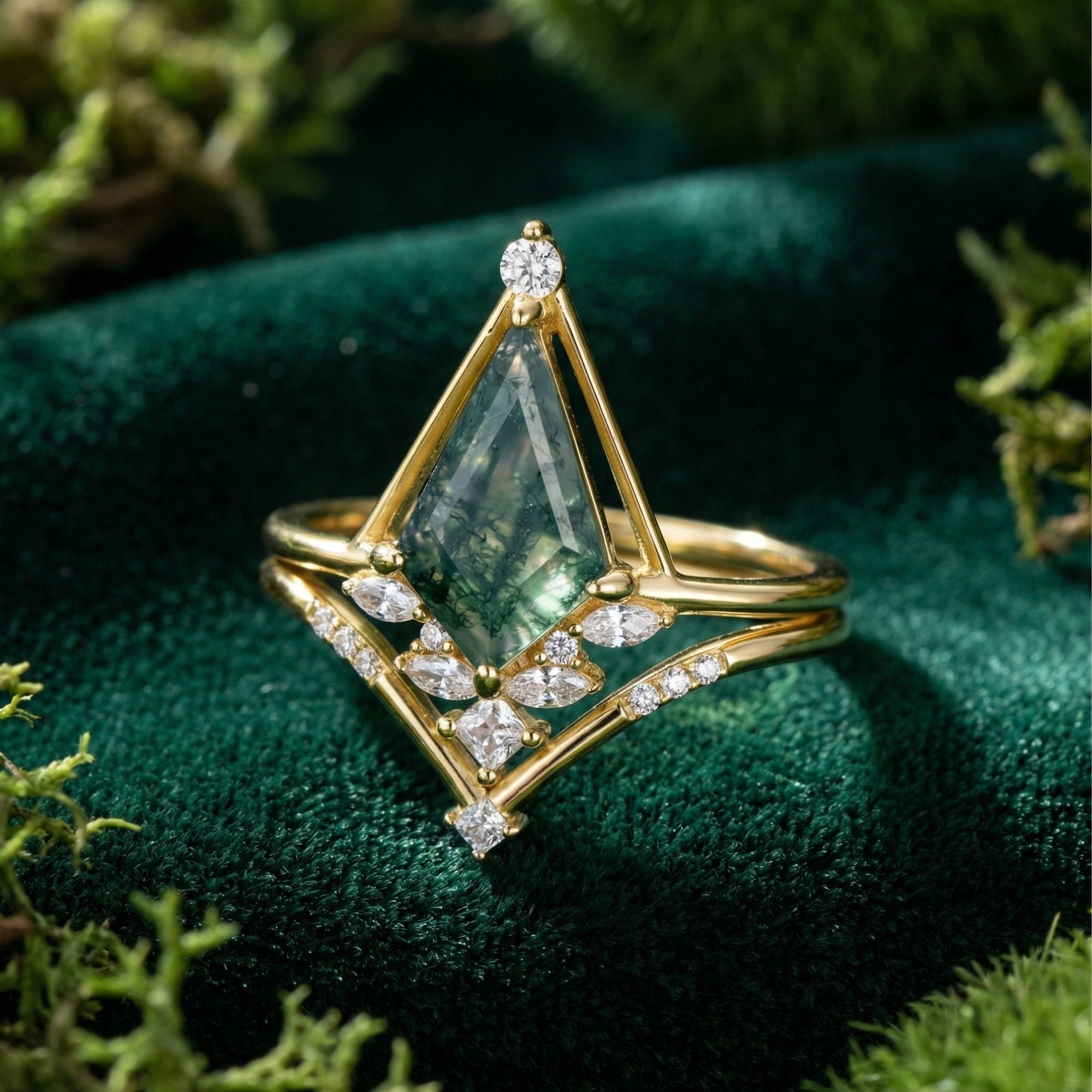 Gold-plated sterling silver ring set with a kite-cut moss agate and diamond accents on green velvet.