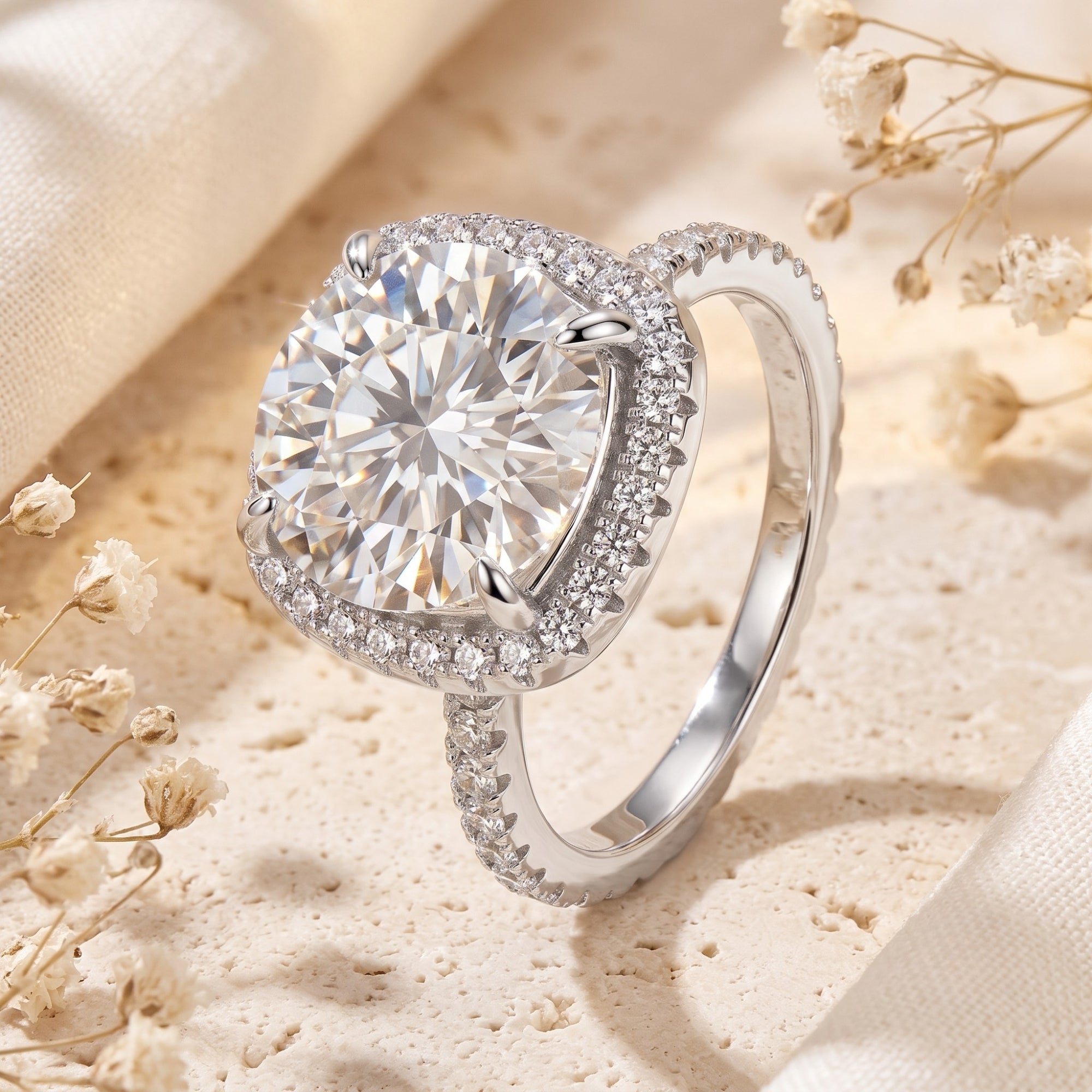 Sterling silver cushion halo ring with round brilliant-cut cubic zirconia on a textured lifestyle background.