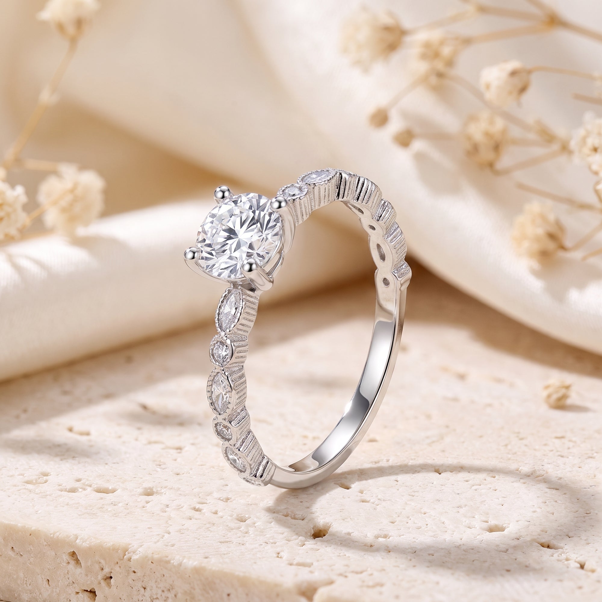 Verona milgrain solitaire ring in S925 silver with round cubic zirconia on a stone and floral background.