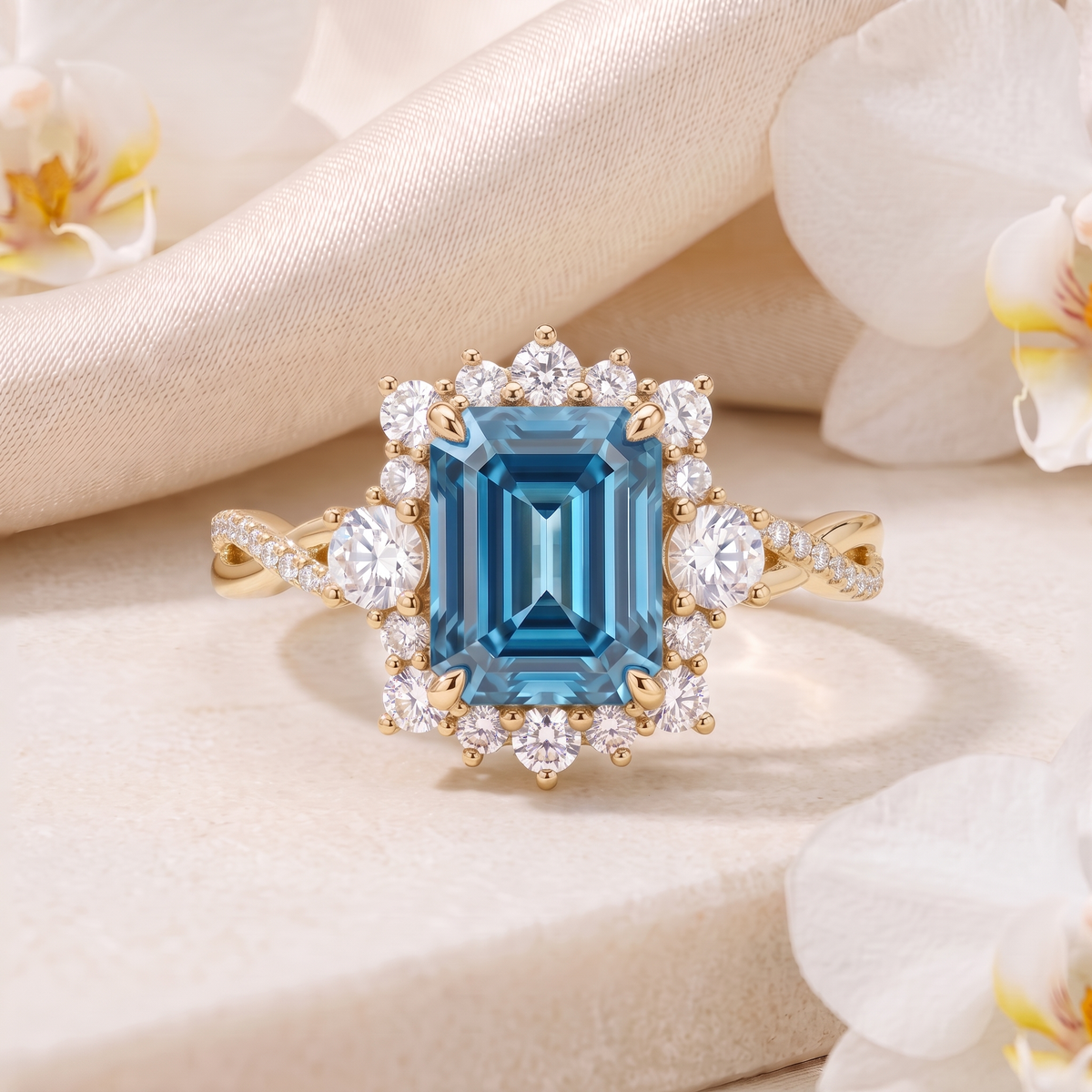 Emerald cut blue moissanite halo engagement ring in yellow gold displayed on a stone surface