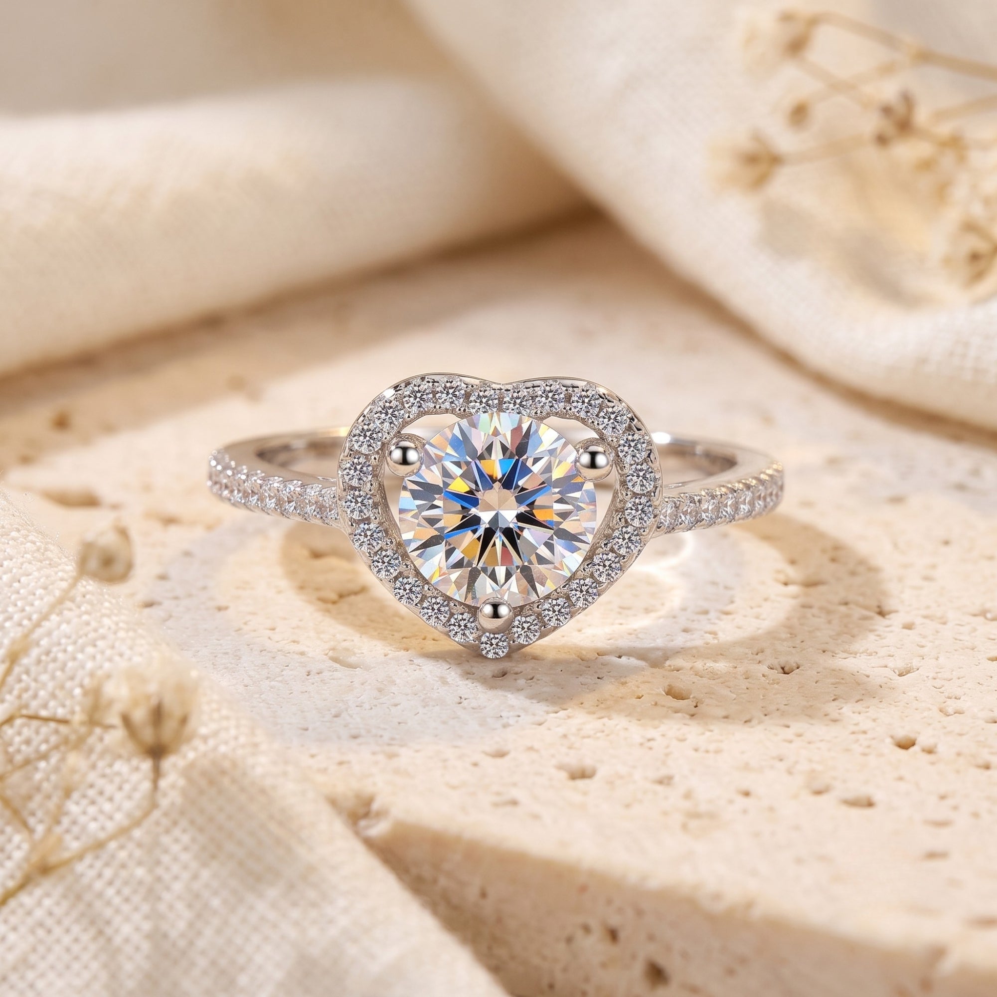 S925 sterling silver heart halo ring with round cubic zirconia on a textured lifestyle background.