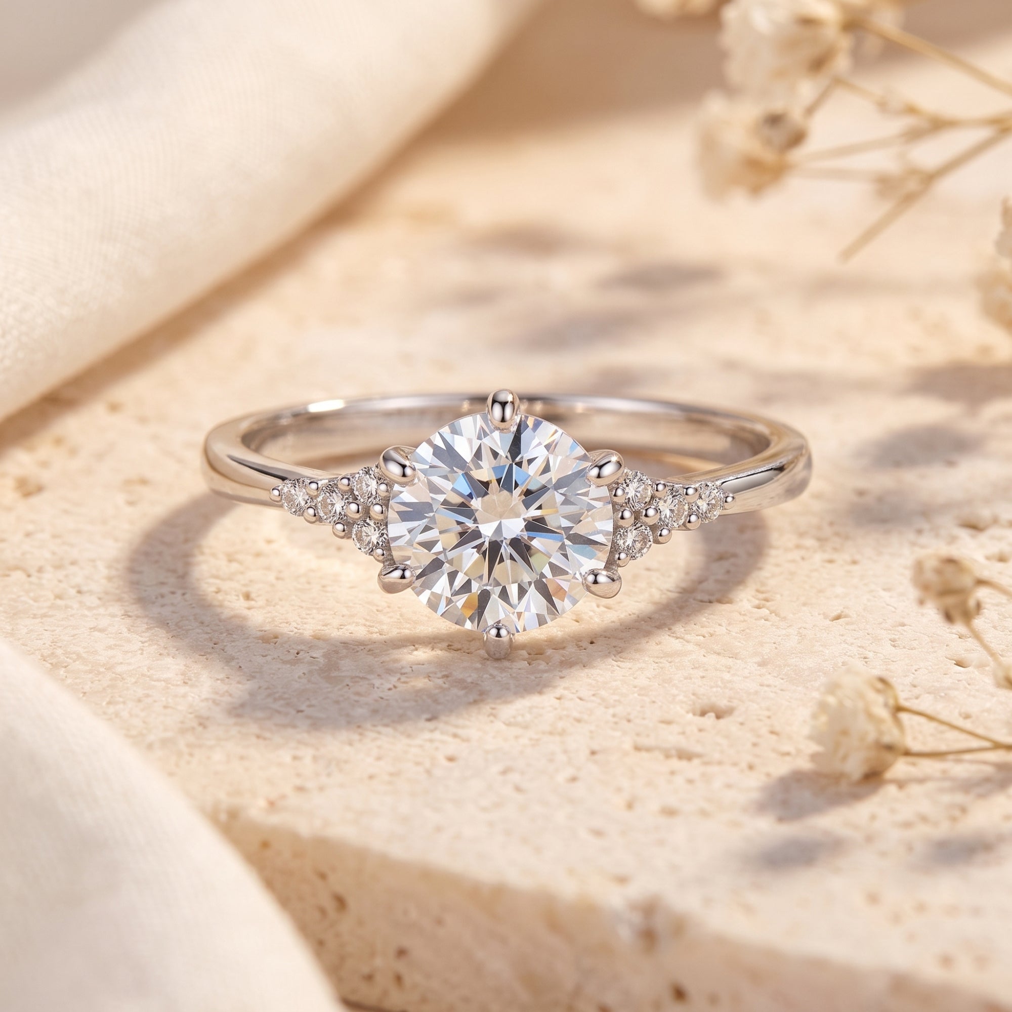 Sterling silver solitaire ring with round simulated diamond on a textured lifestyle surface.