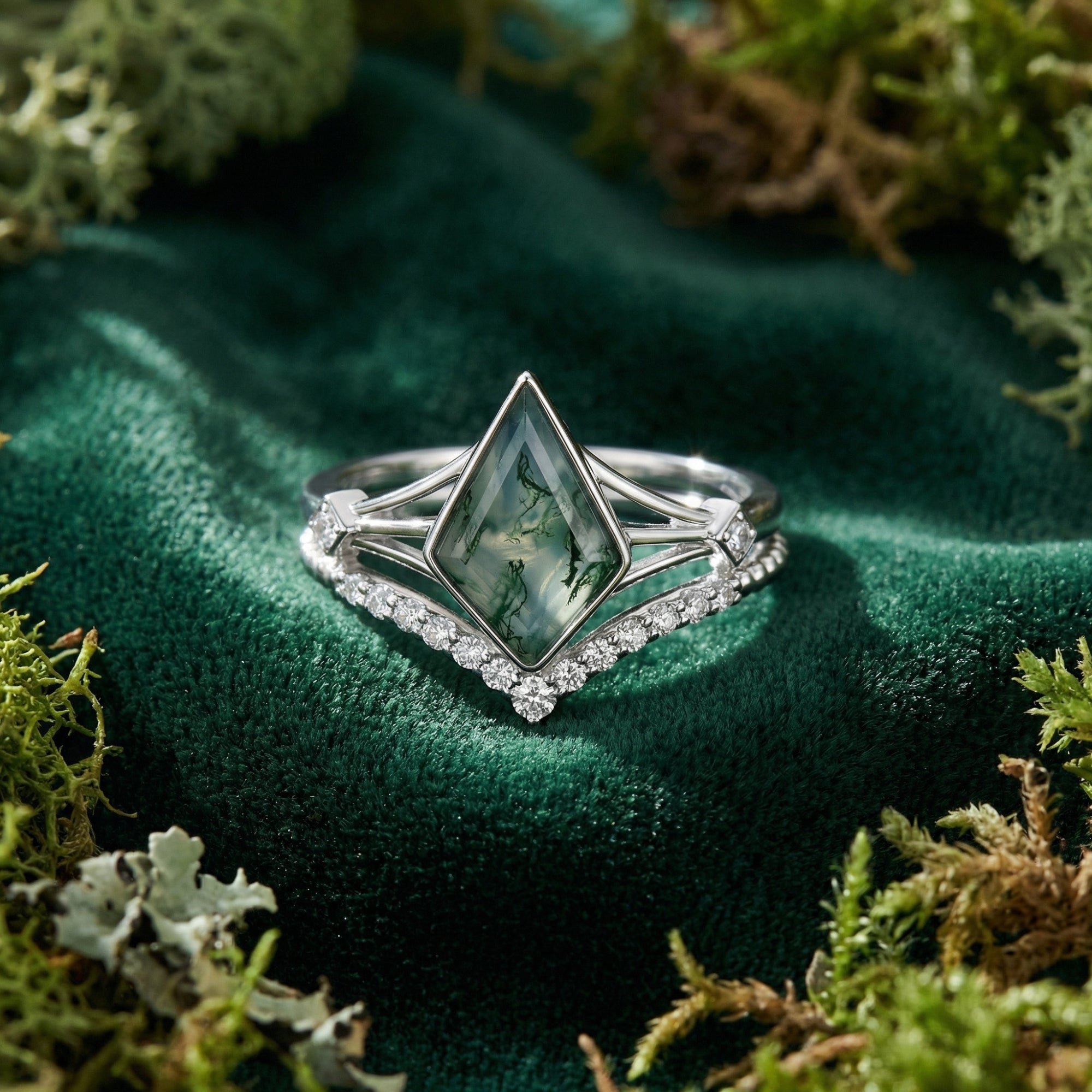 Kite cut moss agate solitaire ring set in S925 sterling silver on a green velvet and moss background.