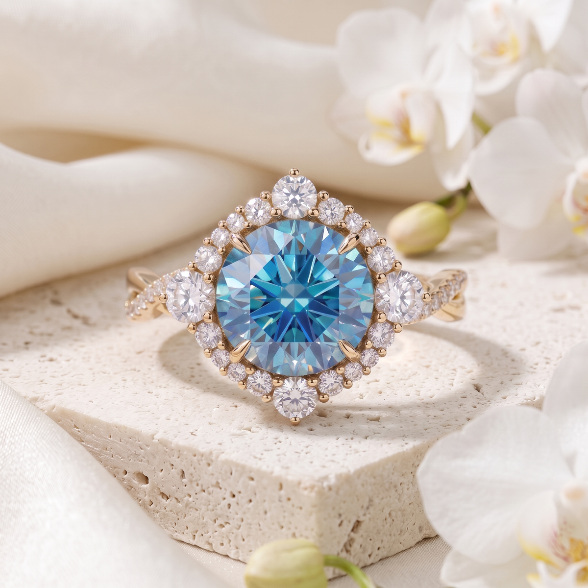 Front view of a yellow gold blue moissanite halo ring with an intricate diamond border.