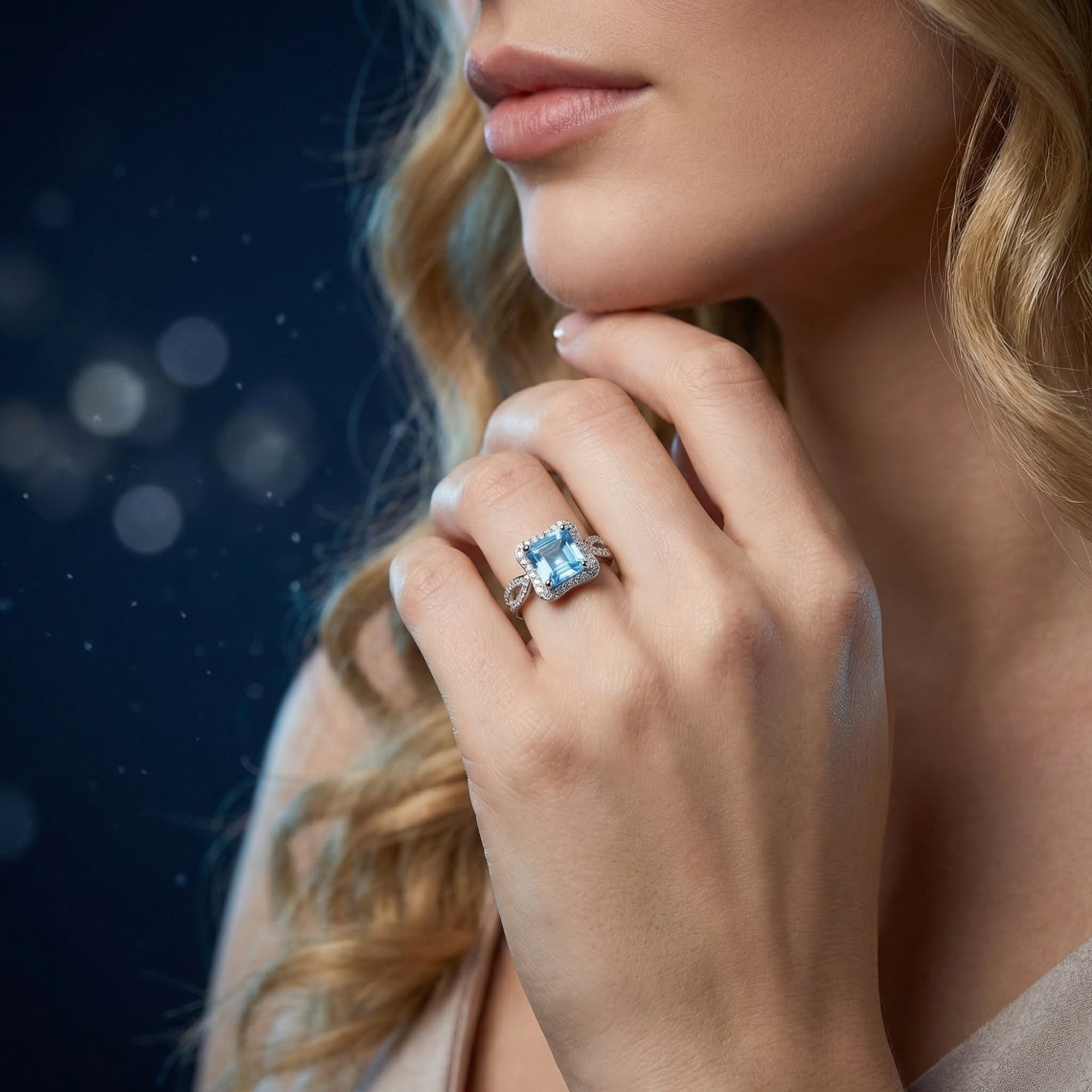 Woman wearing the princess cut Swiss Blue topaz sterling silver ring on her finger.