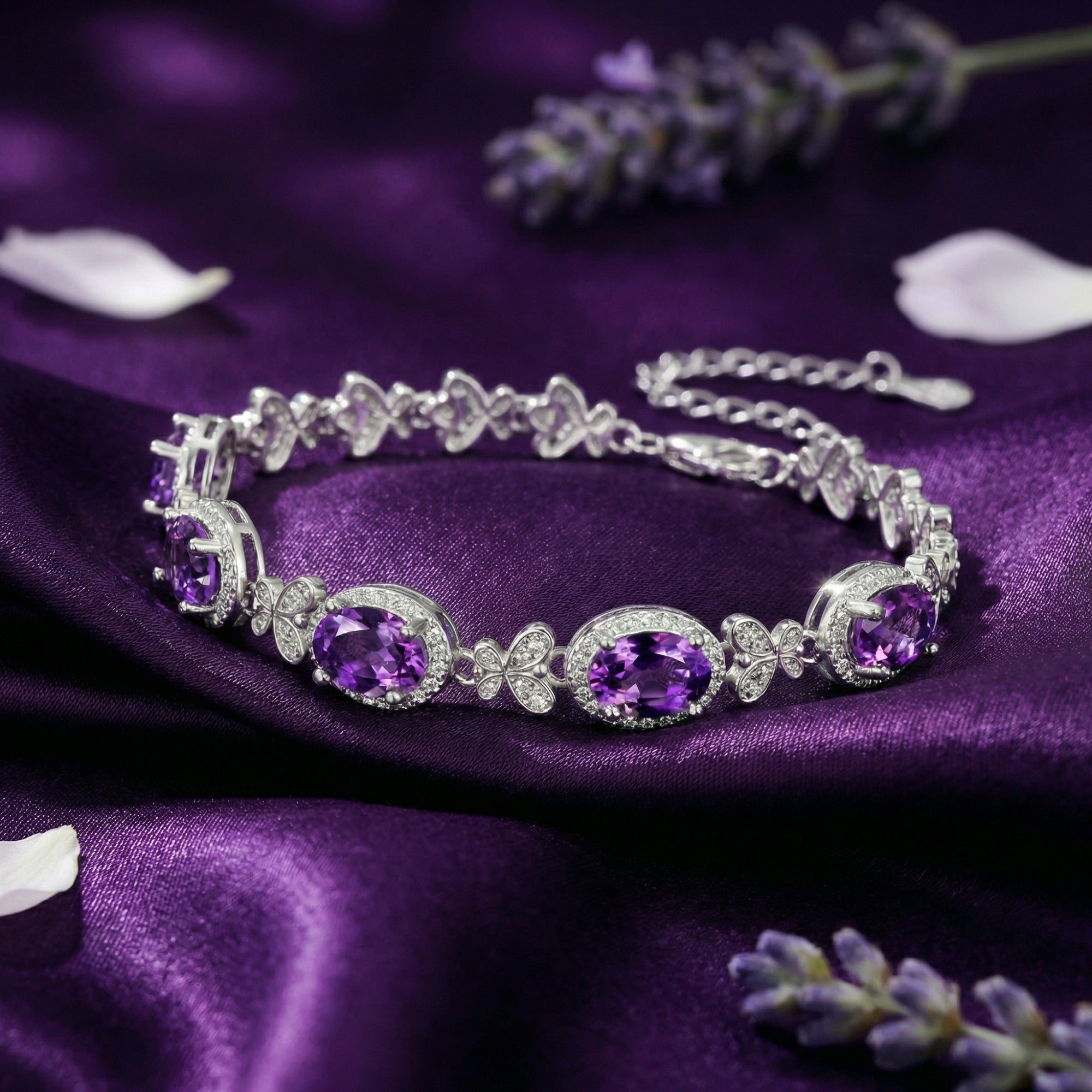 Close-up of oval cut amethysts and butterfly links on the Quintara S925 sterling silver station bracelet.