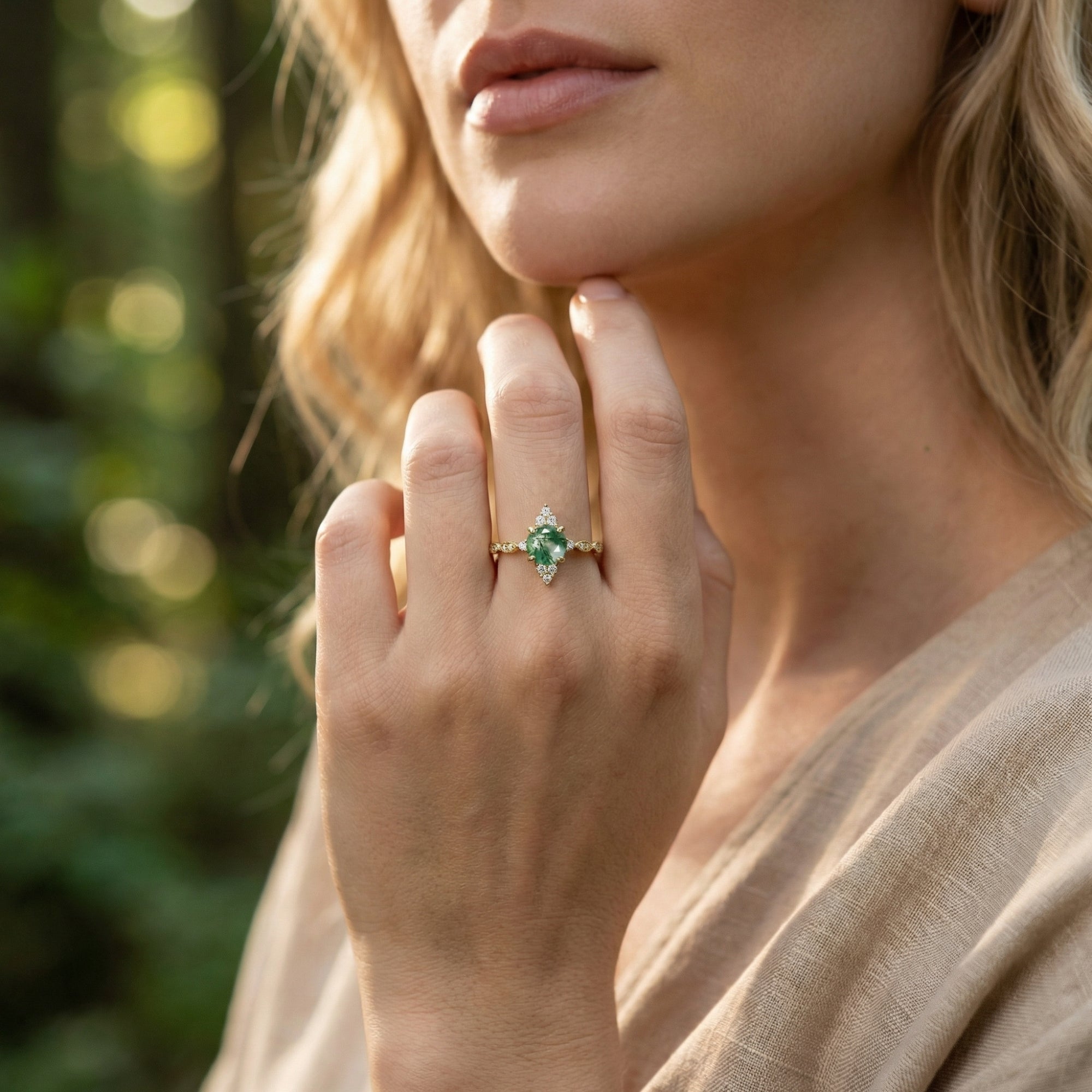 Model wearing the gold moss agate sunburst ring on her hand, showing the ring's fit and natural stone.