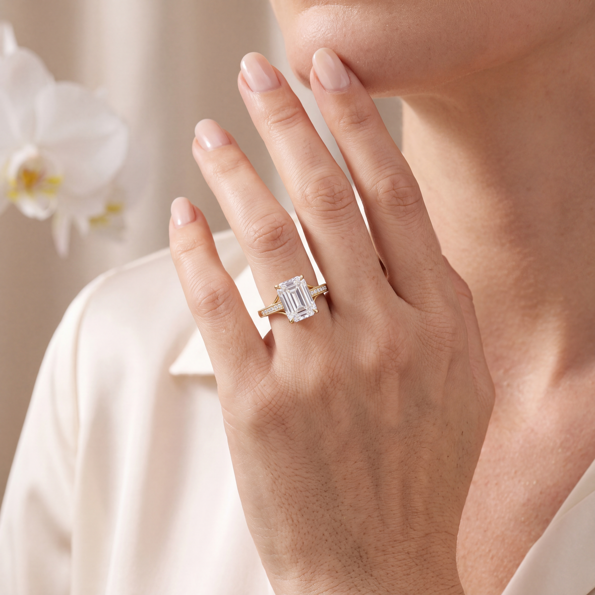 Model wearing the yellow gold emerald-cut moissanite split shank ring.