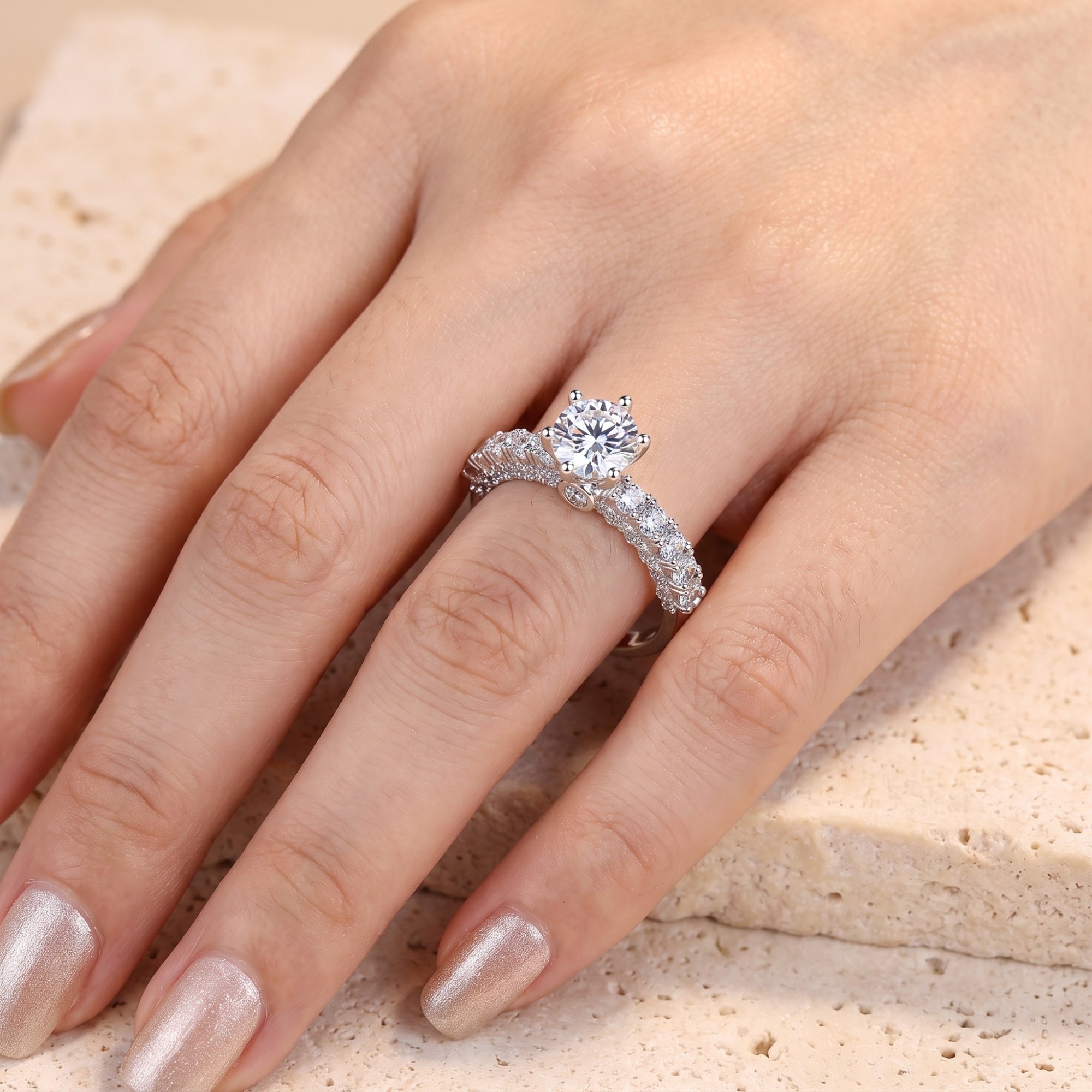 Round brilliant-cut cubic zirconia silver ring shown on a hand.