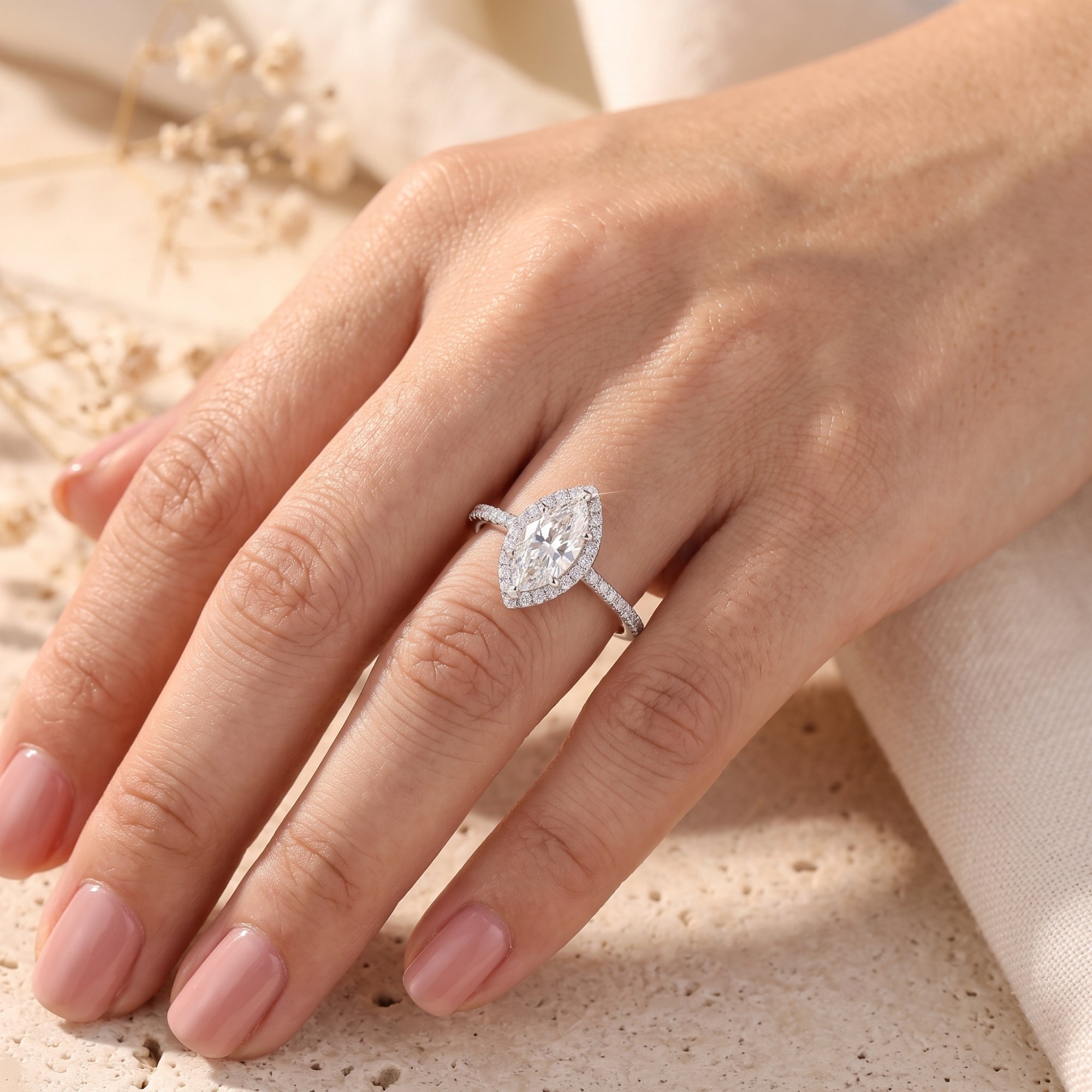 S925 sterling silver marquise halo promise ring worn on a model's hand in a lifestyle setting.