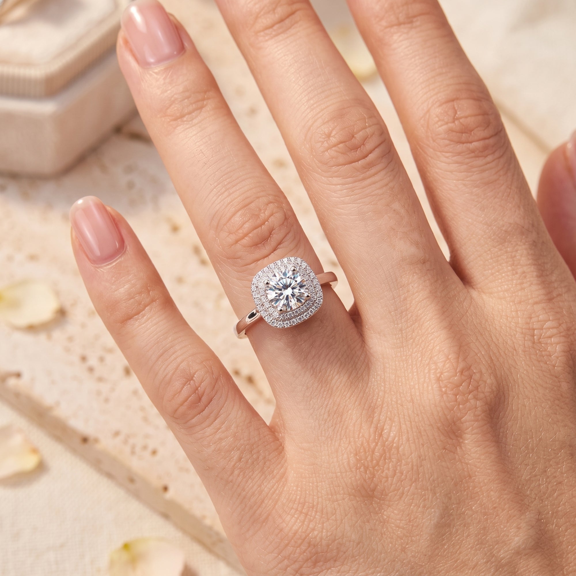 Round brilliant cubic zirconia promise ring in sterling silver worn on a woman's finger.