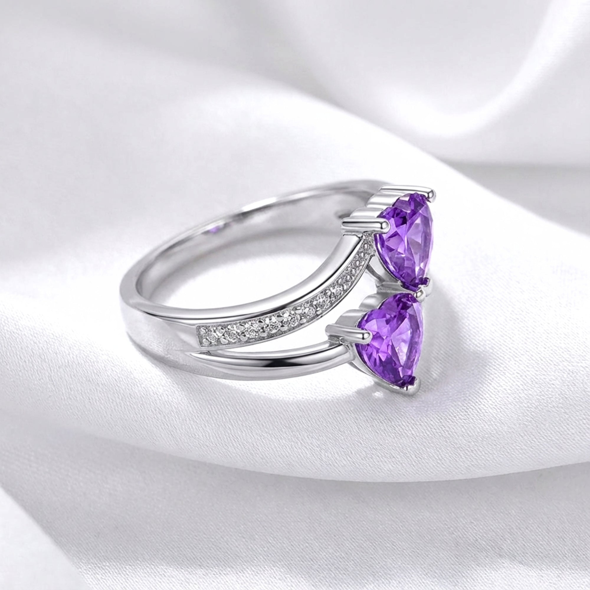 Angled side view of the S925 sterling silver Adara ring showing the bypass setting and simulated amethysts.