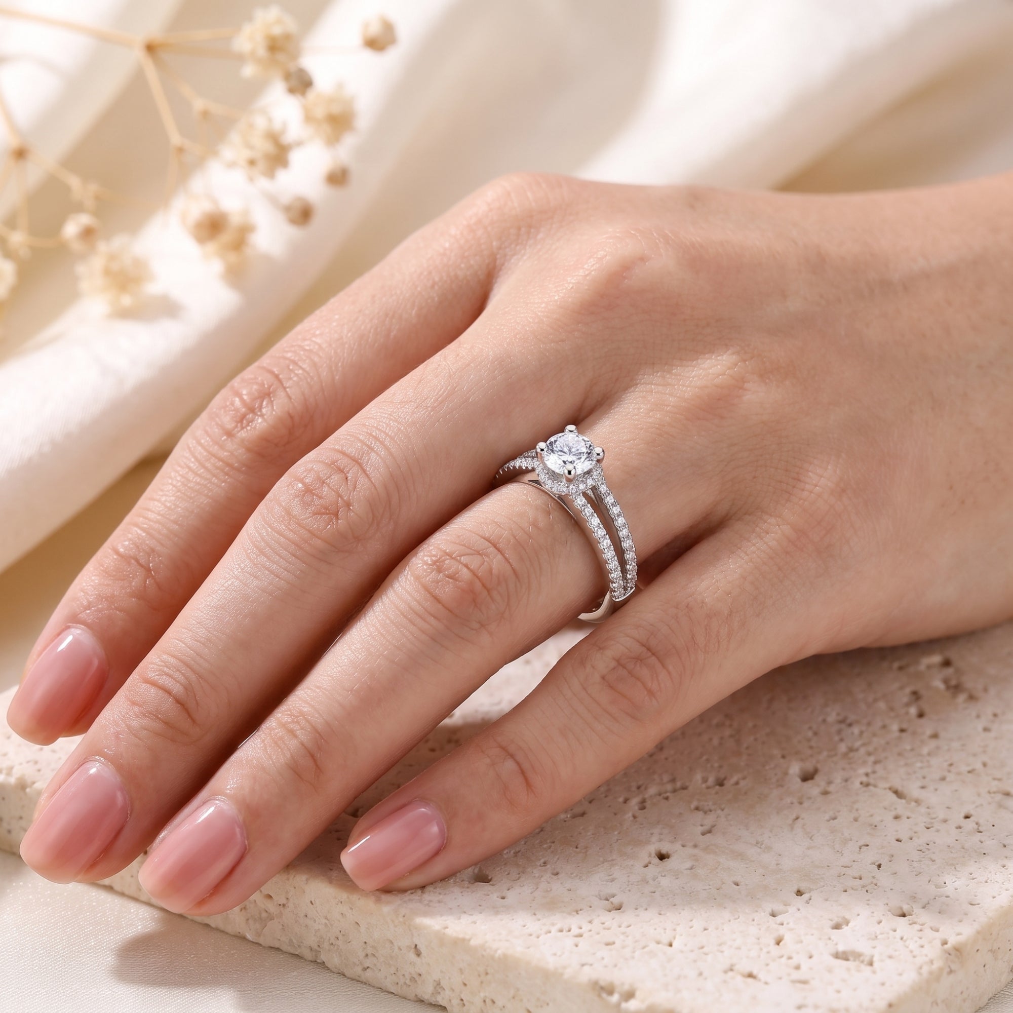 S925 sterling silver split shank ring with round cubic zirconia worn on a model's hand.