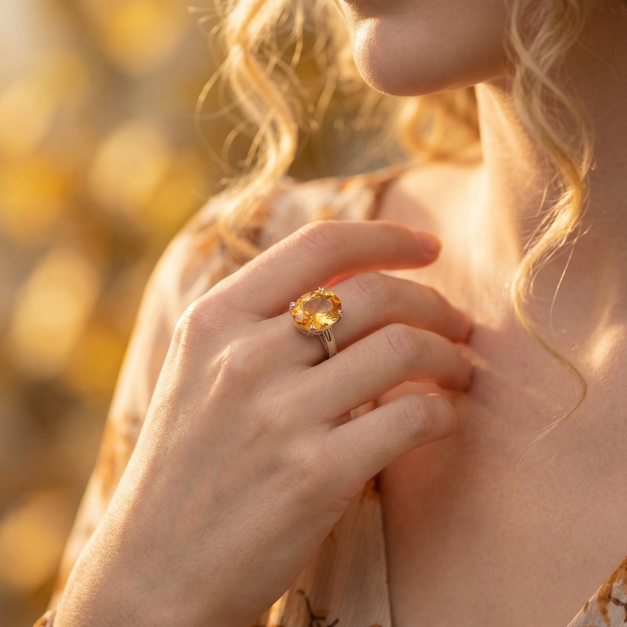 Model wearing the large oval natural citrine sterling silver ring on her hand.