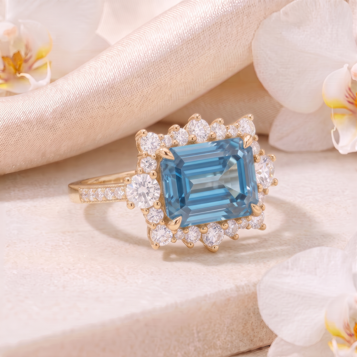 Angled perspective view of an emerald-cut blue moissanite halo ring in yellow gold.