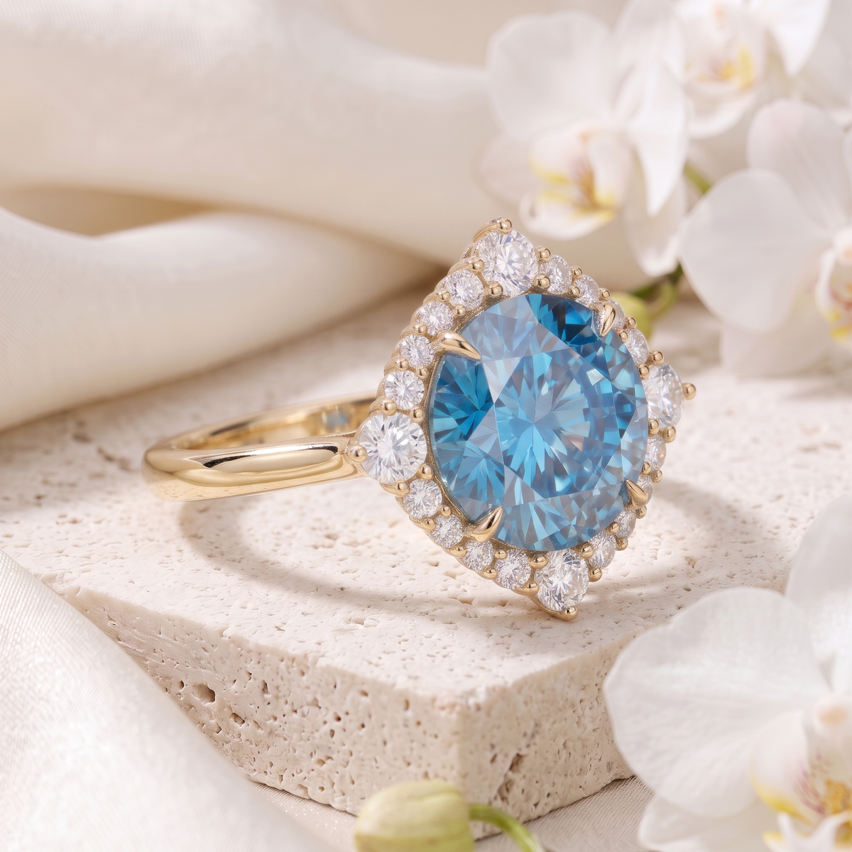An angled view of a yellow gold engagement ring with a round blue moissanite center stone and diamond halo.