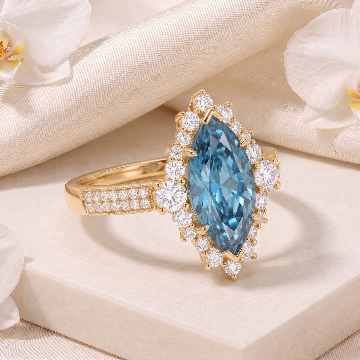 Angled view of a yellow gold marquise blue moissanite halo ring.