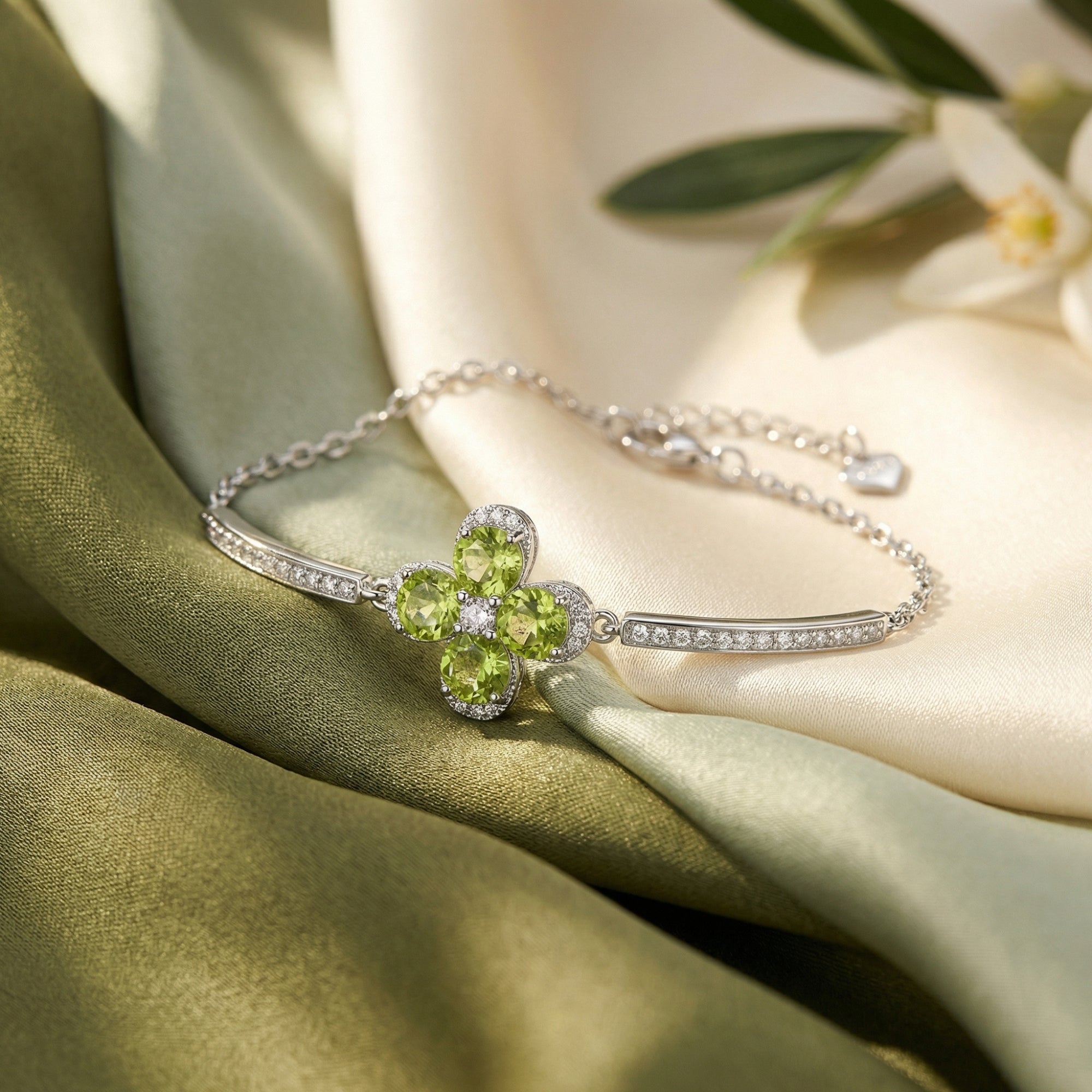 Close-up of the round cut natural peridot clover and pavé-set bars on the S925 sterling silver station bracelet.