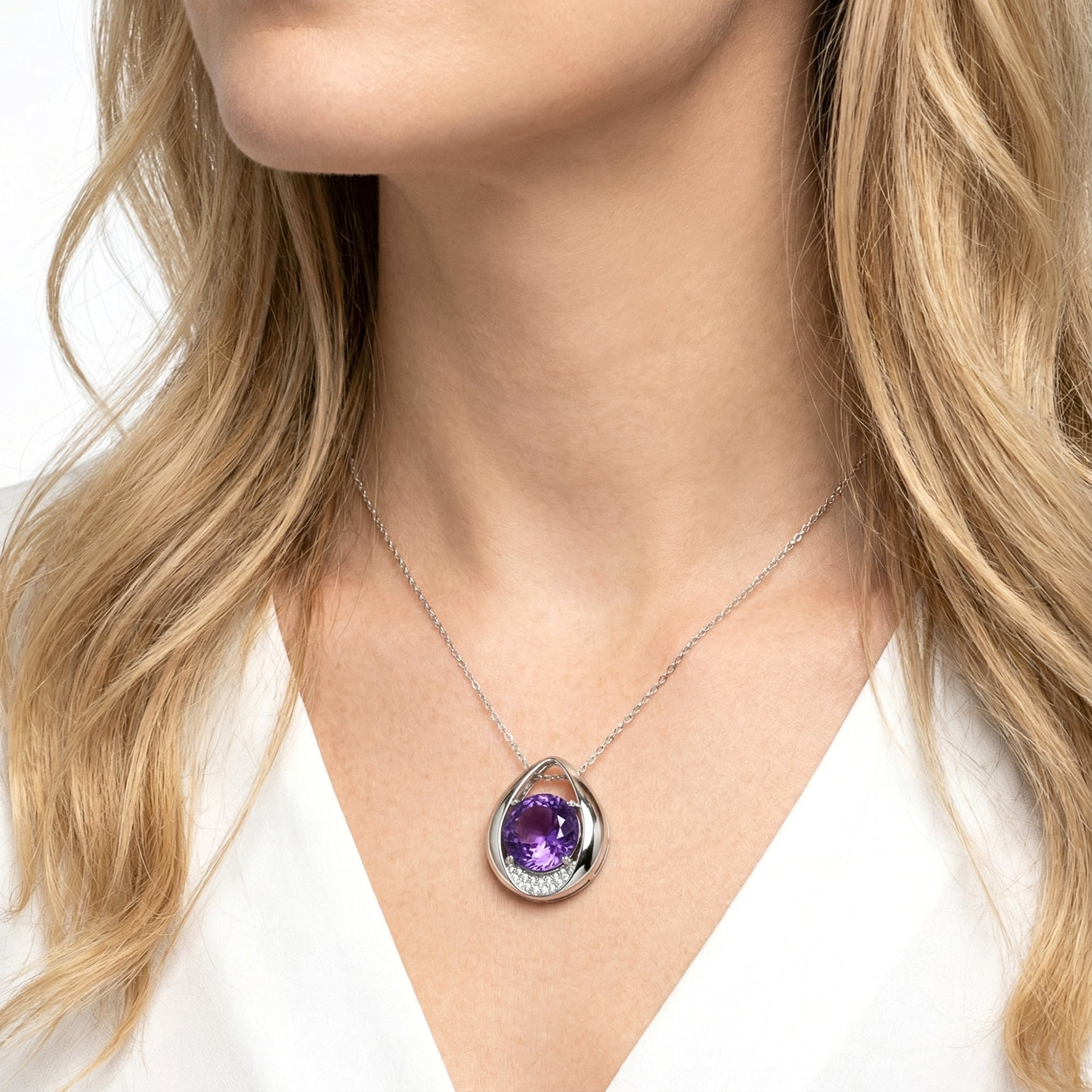 Model wearing the S925 sterling silver Isolde drop necklace with a round cut purple simulated amethyst stone.