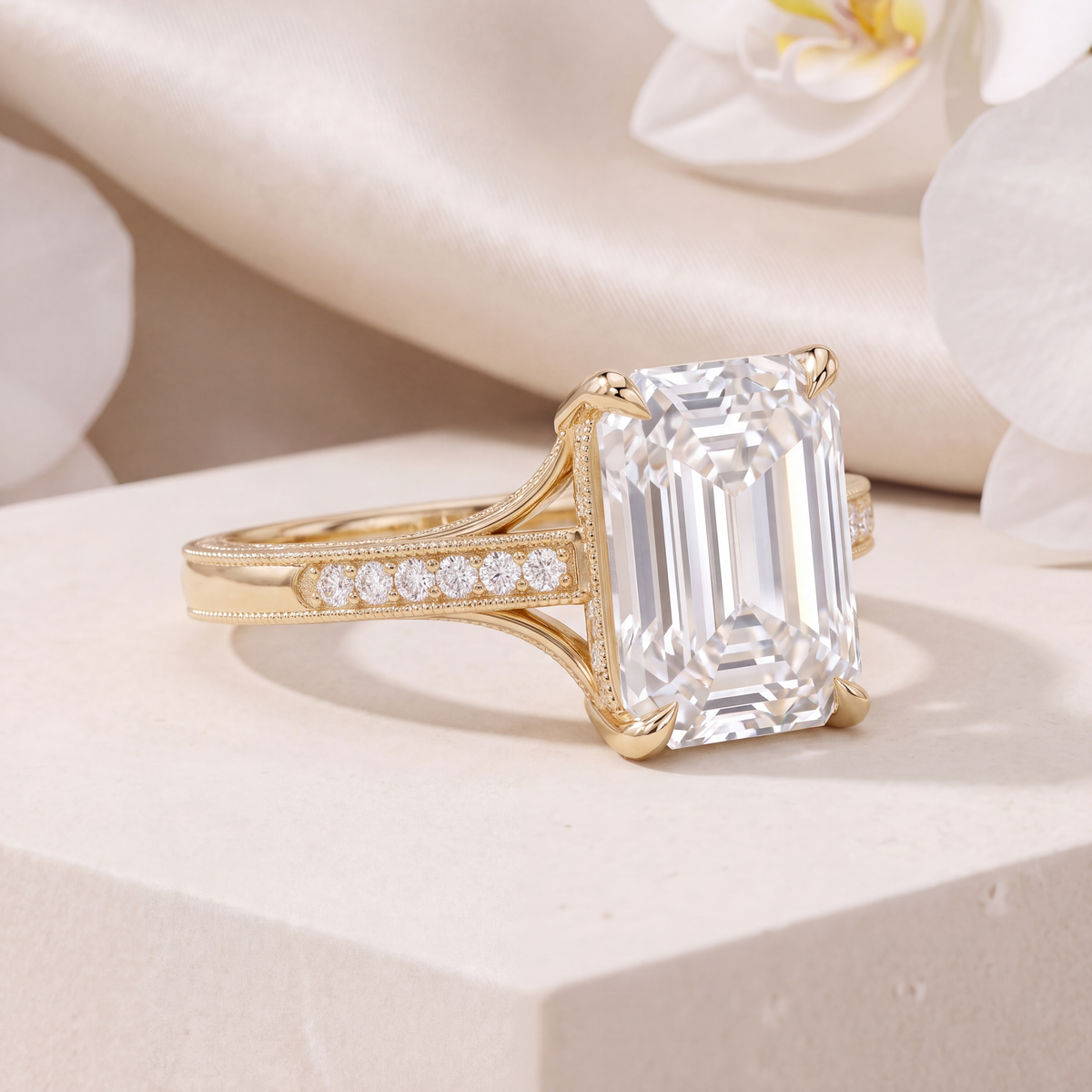 Side angle perspective view of the yellow gold emerald-cut moissanite ring highlighting split shank detail.