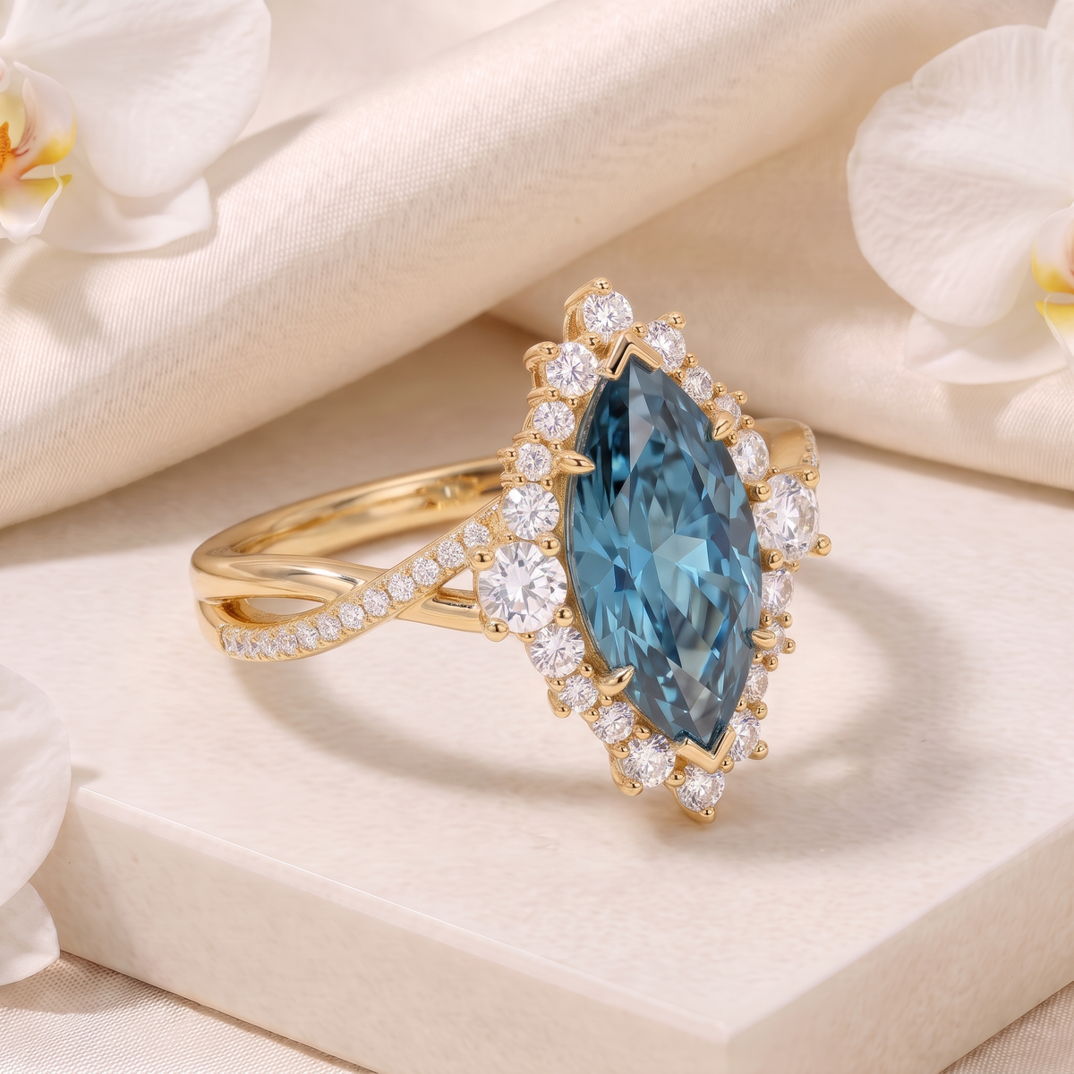 Angled product view of a yellow gold blue marquise moissanite ring with a diamond halo and twisted band.