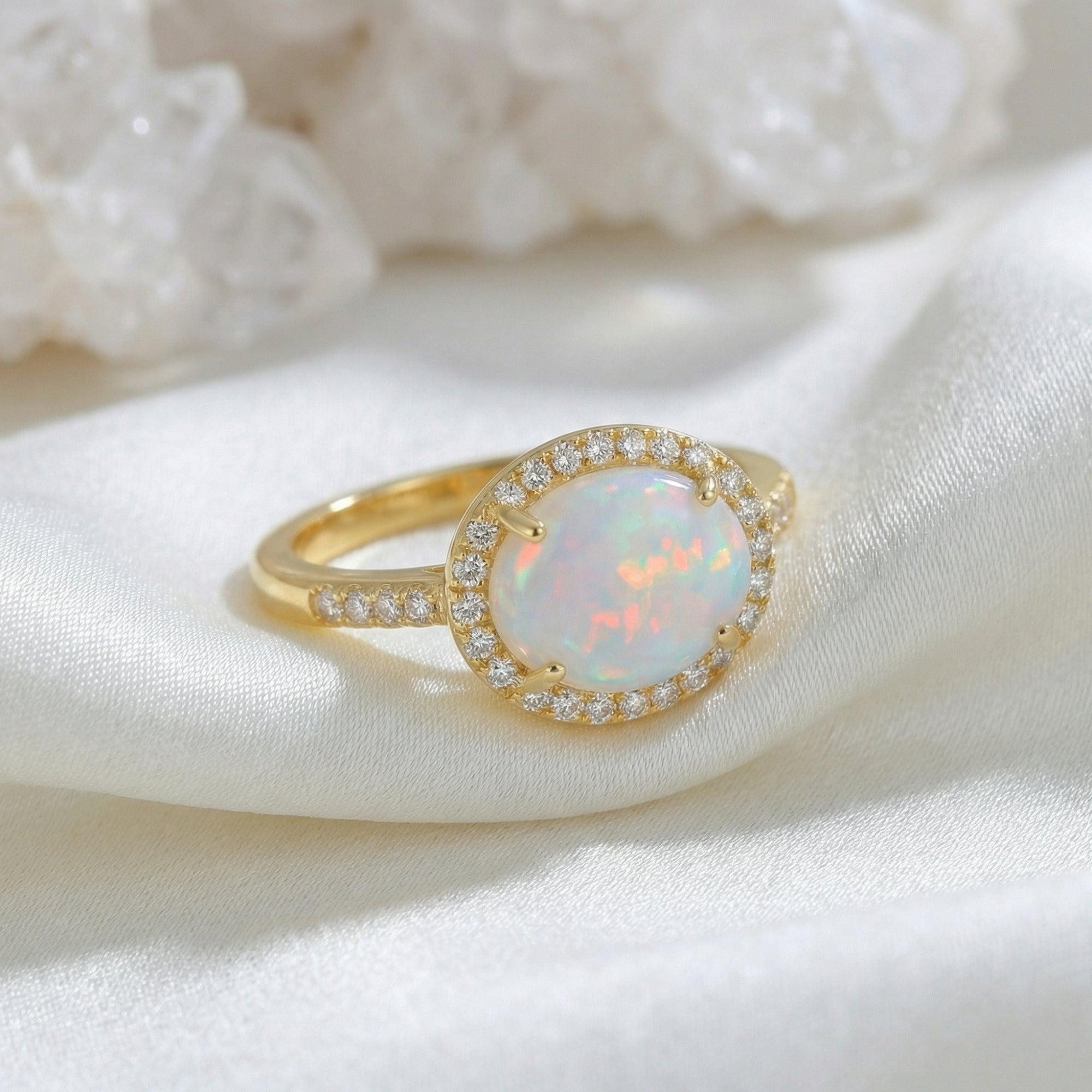 Angled close-up of the gold vermeil Magnolia ring showing the natural oval cut opal and pavé band.