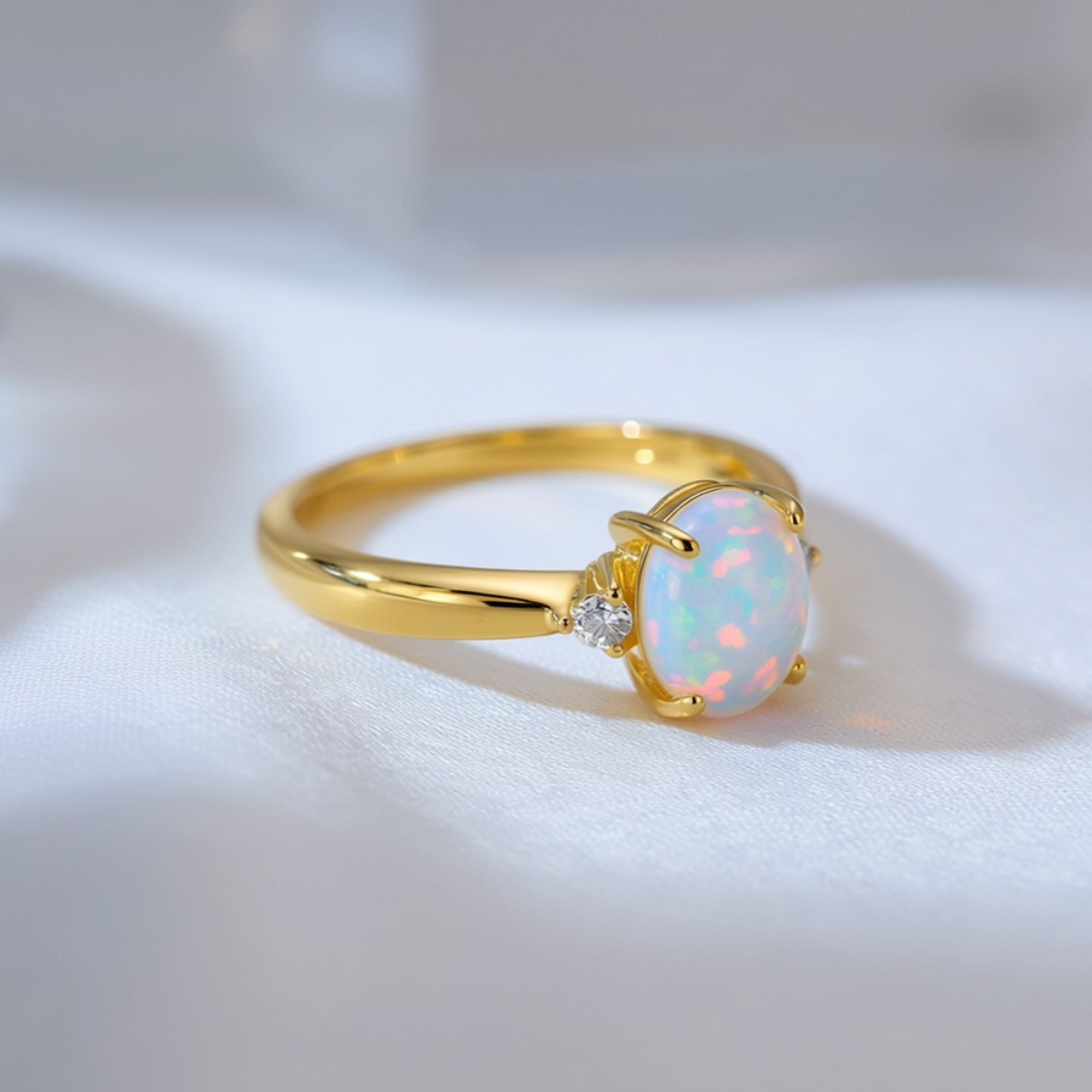 Close-up side view of a gold-tone S925 silver ring featuring a natural oval opal with vibrant play-of-color.
