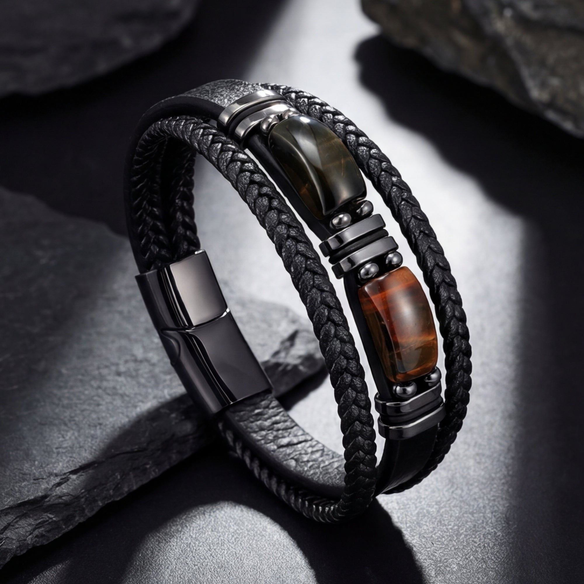 Side view of a men's black braided leather bracelet with a 316L black stainless steel clasp and tiger's eye stones.