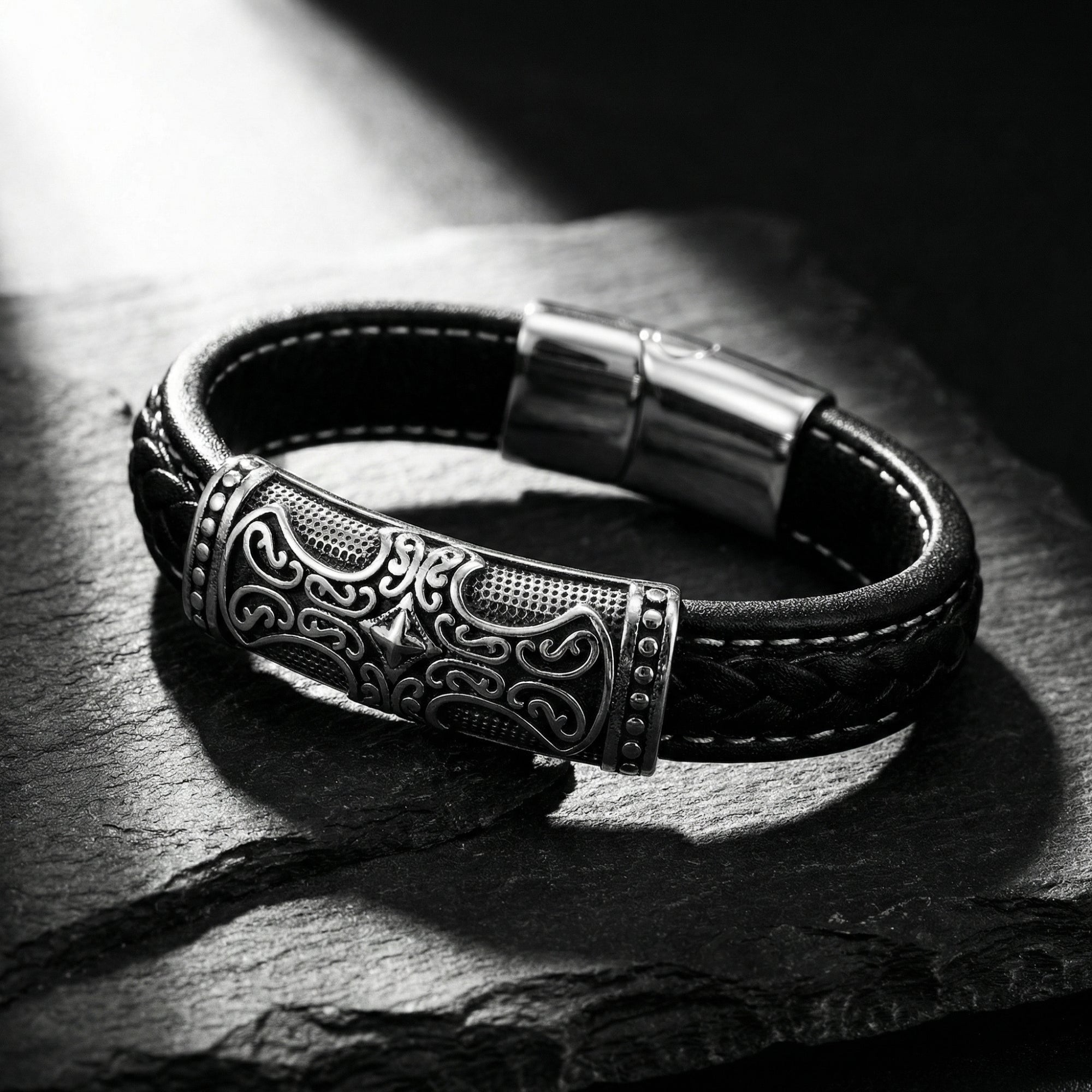 Macro view of the intricately detailed 316L stainless steel clasp on the Runeforge braided leather bracelet.