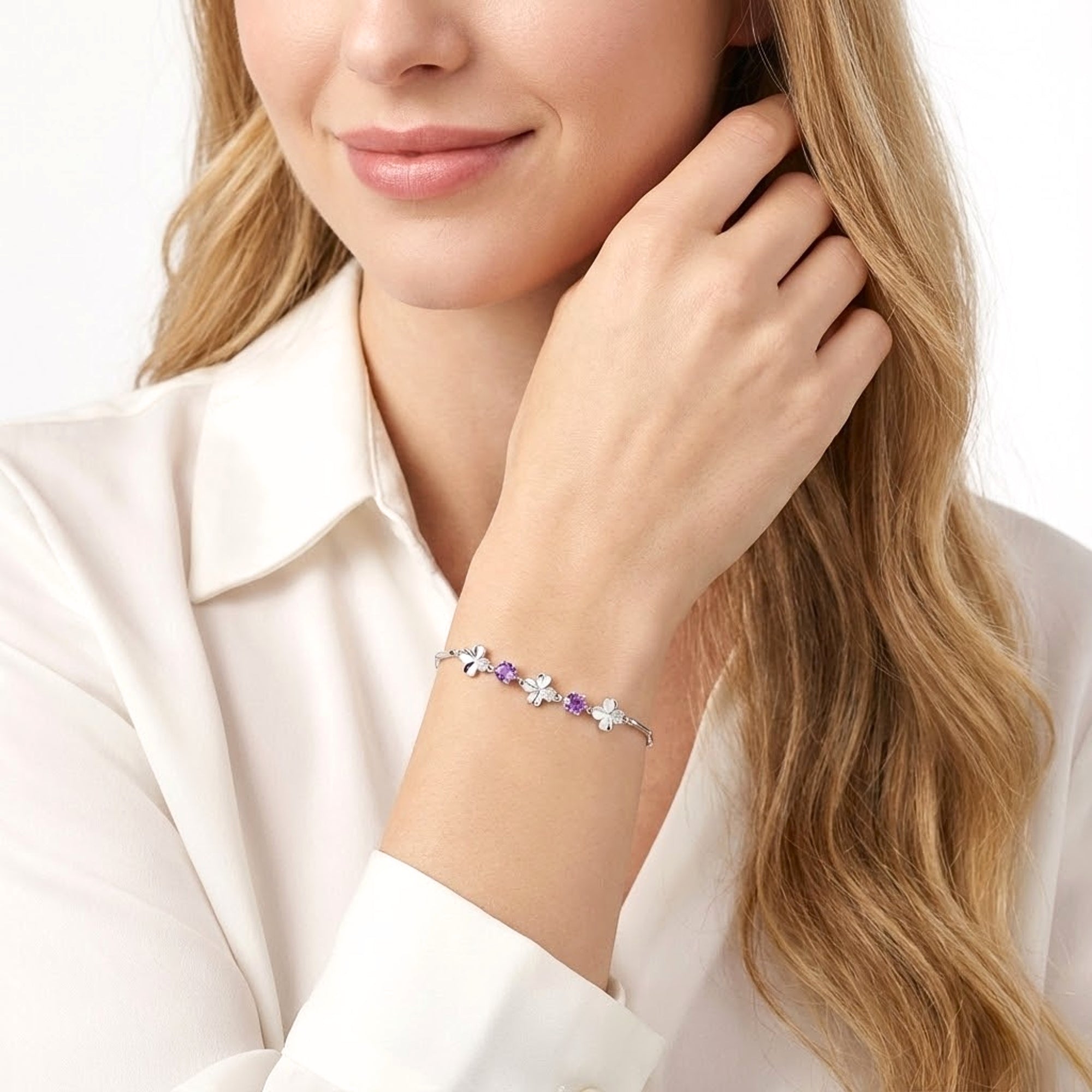 Woman wearing the sterling silver Amoret bracelet with purple simulated amethyst stones on her wrist.