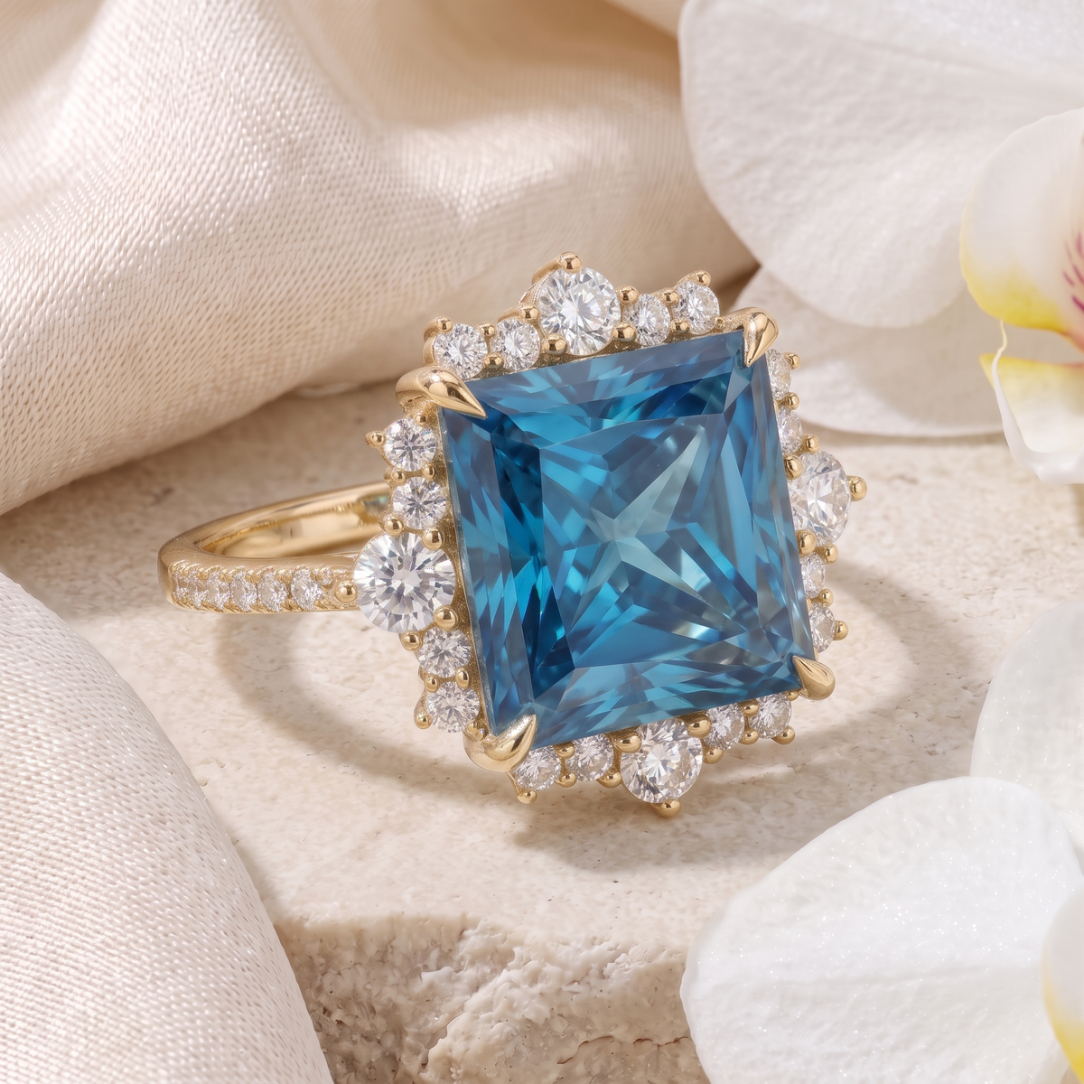 Side-angled view of a yellow gold princess-cut blue moissanite halo engagement ring.