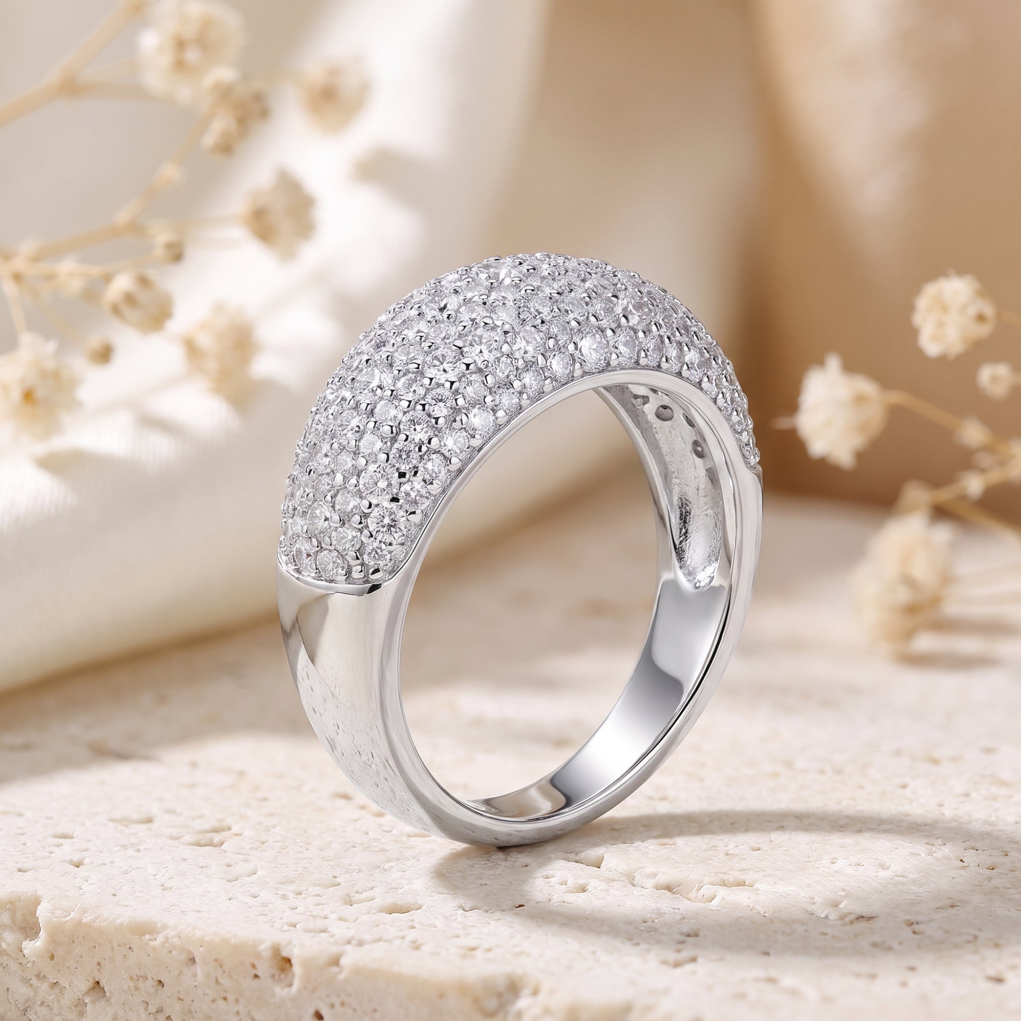 Macro view of silver dome ring's micro-pave setting and CZ stones.