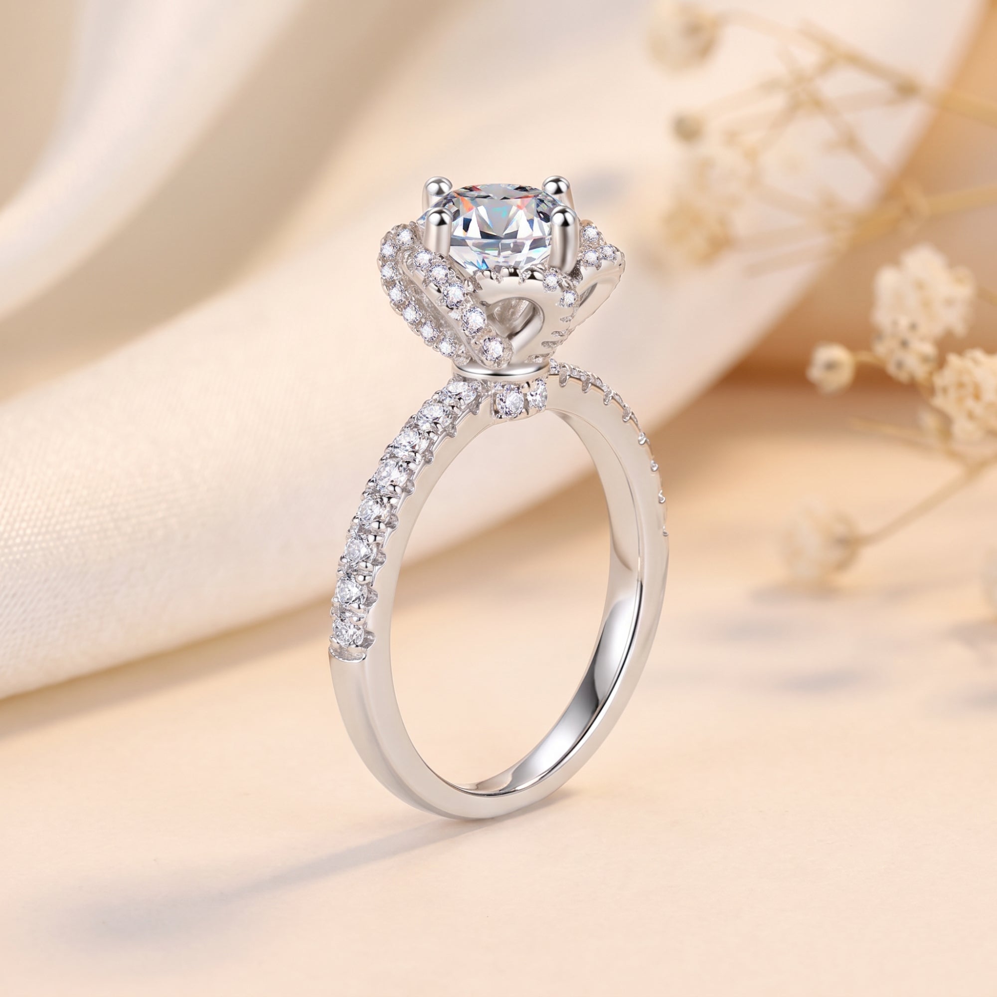 Side profile of a silver rosette swirl halo ring showing the round-cut simulated diamond and pavé setting.