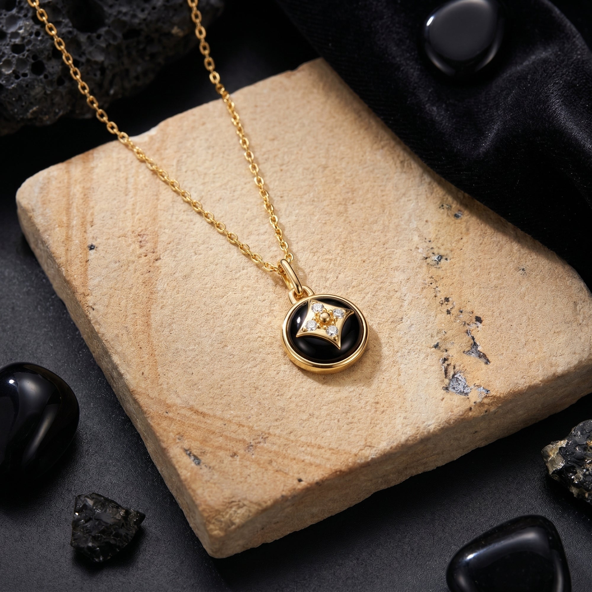 Top-down close-up of the gold plated round natural onyx pendant with a star-shaped diamond detail.