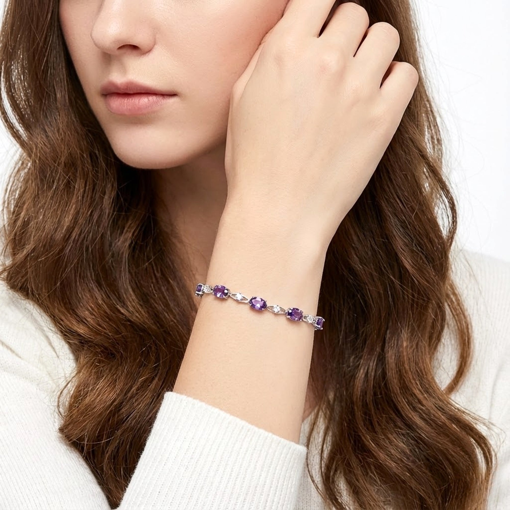 Model wearing the Lysandra sterling silver link bracelet with purple simulated amethyst stones on her wrist.