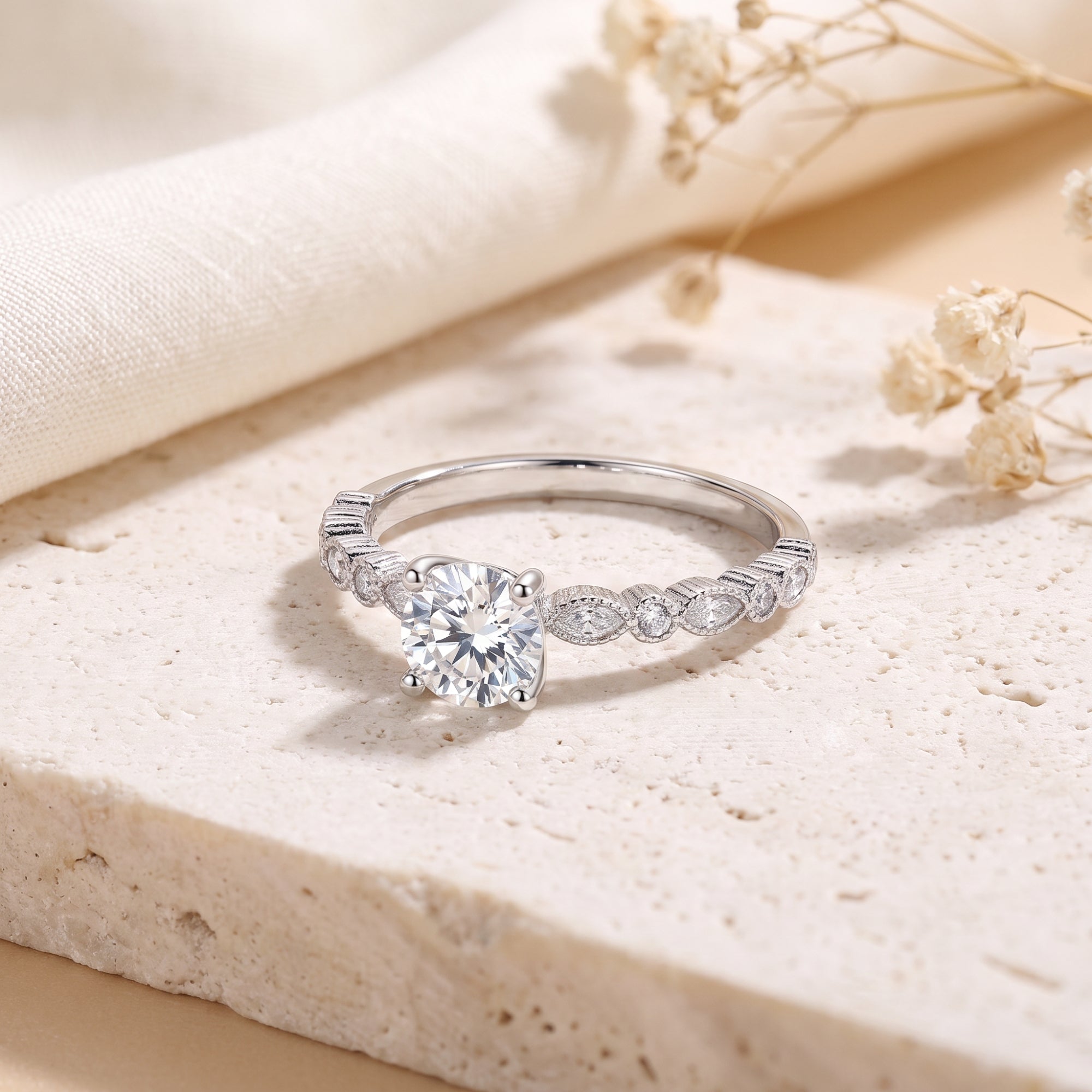 S925 silver solitaire ring featuring a round cubic zirconia and milgrain band on a textured surface.