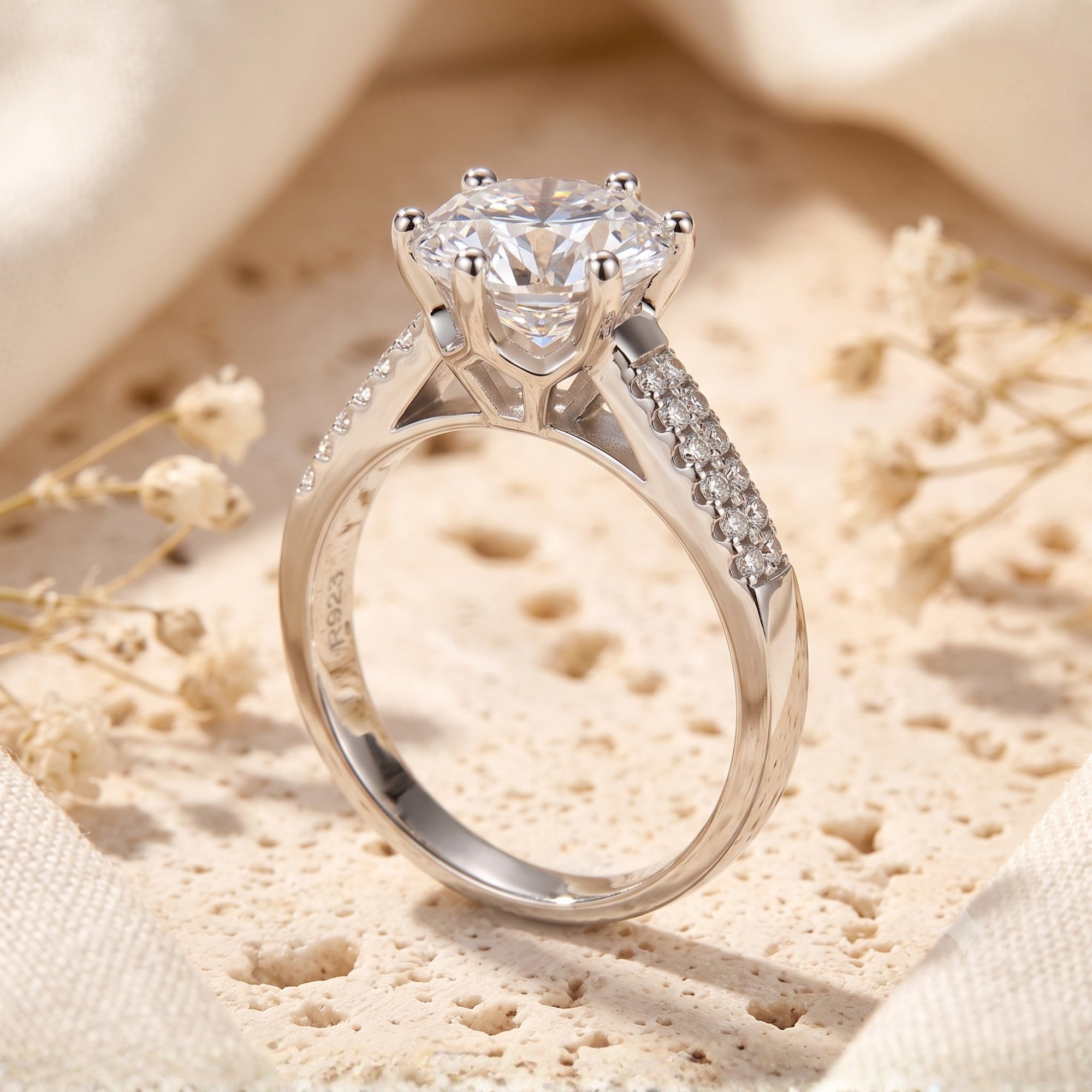 Side profile of a sterling silver six-prong ring with a round-cut simulated diamond.