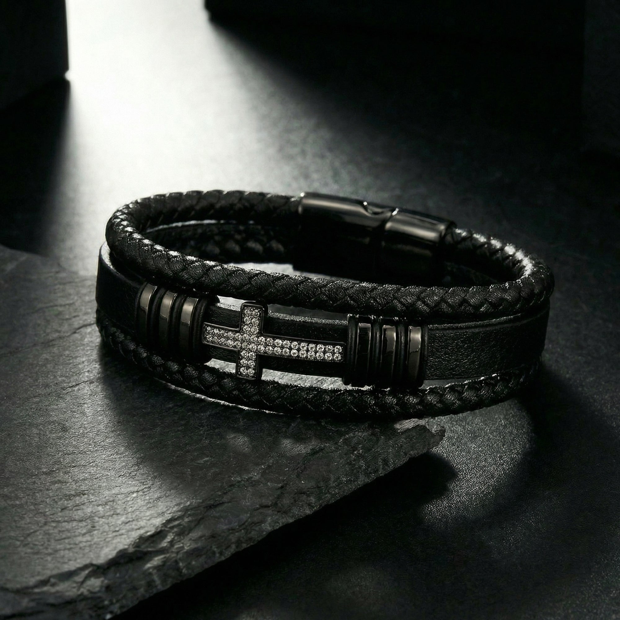 Close-up of the black braided leather and stone-encrusted black PVD steel cross on the Ironcross bracelet.