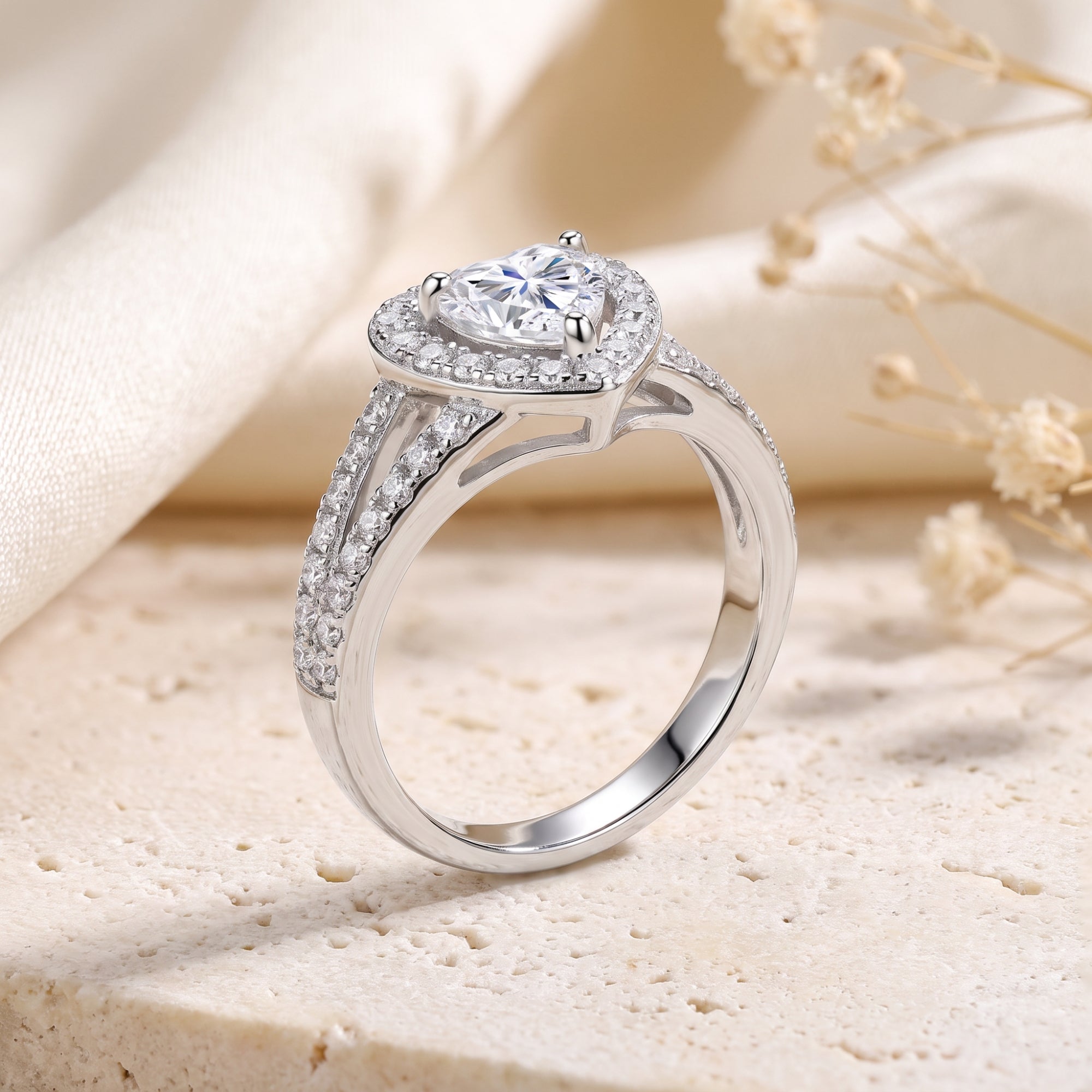 Side profile of a silver heart-cut CZ halo ring highlighting the split-shank pavé band.