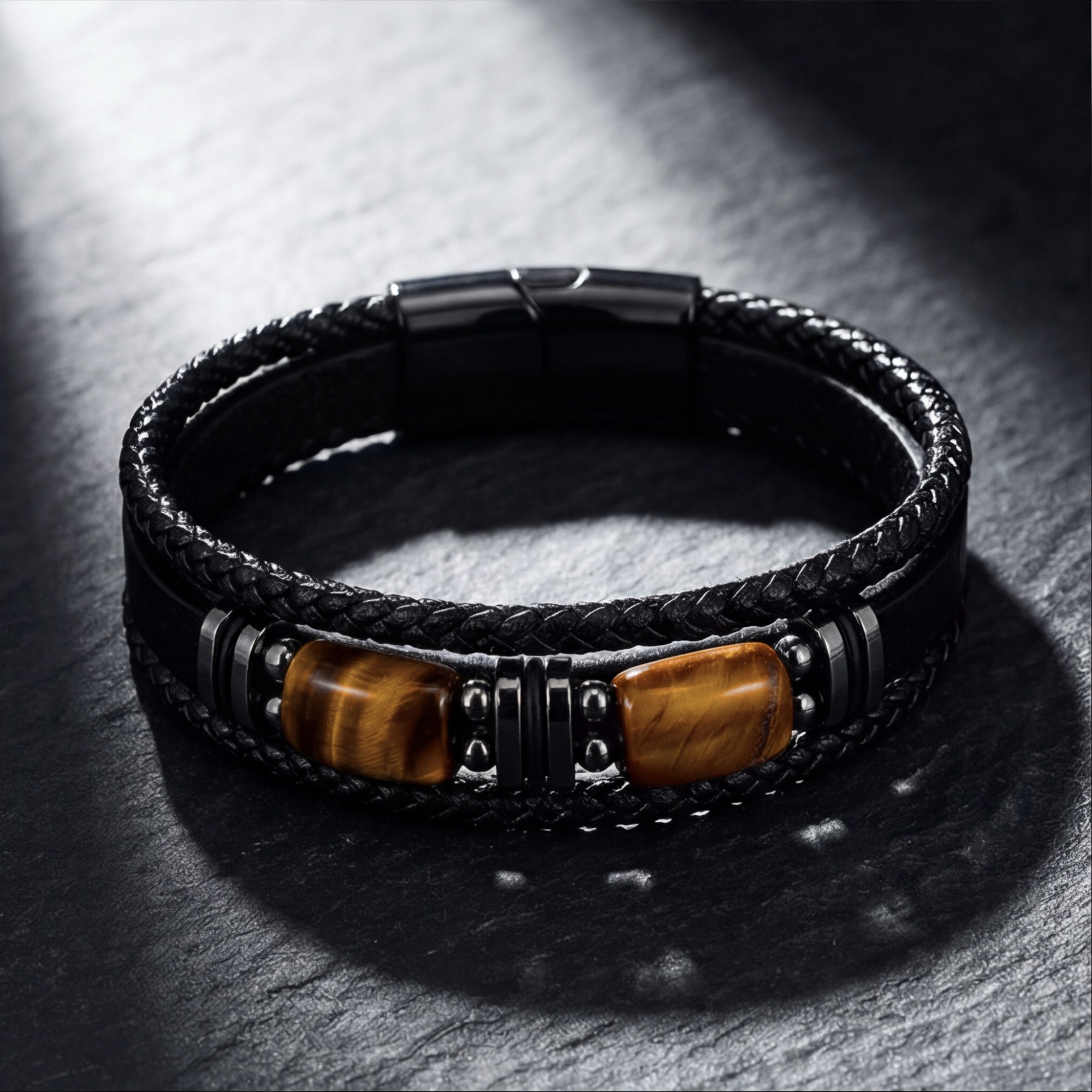 Detail of natural Tiger's Eye stones and black 316L stainless steel spacers on a multi-strand leather bracelet.